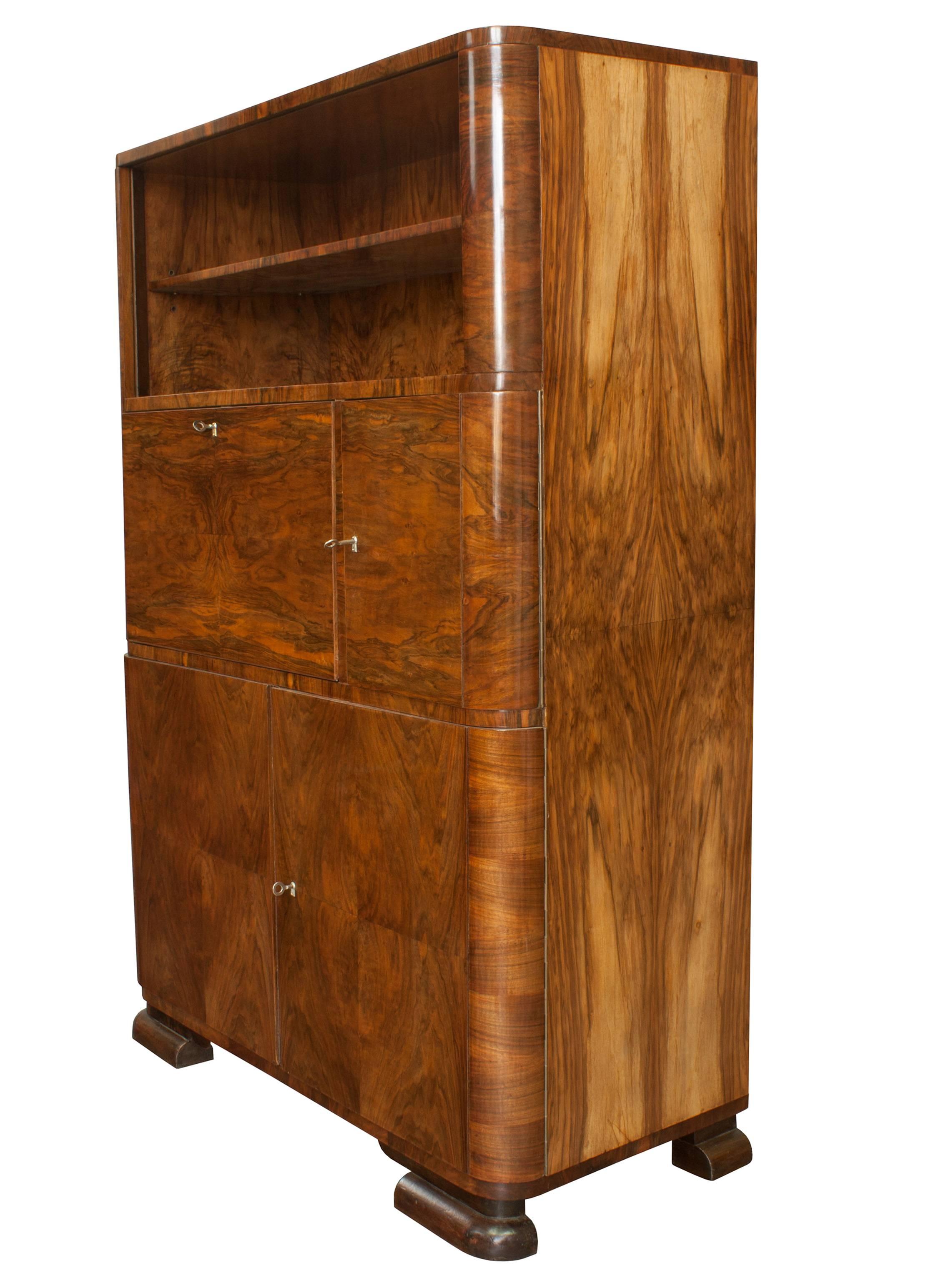 This is a very rare Art Deco cabinet designed by Jindrich Halabala and produced by UP Brno, Czechoslovakia in 1930s. Quality materials and elegant curves are typical for Halabala’s furniture. This particular piece has got a stunning rich walnut