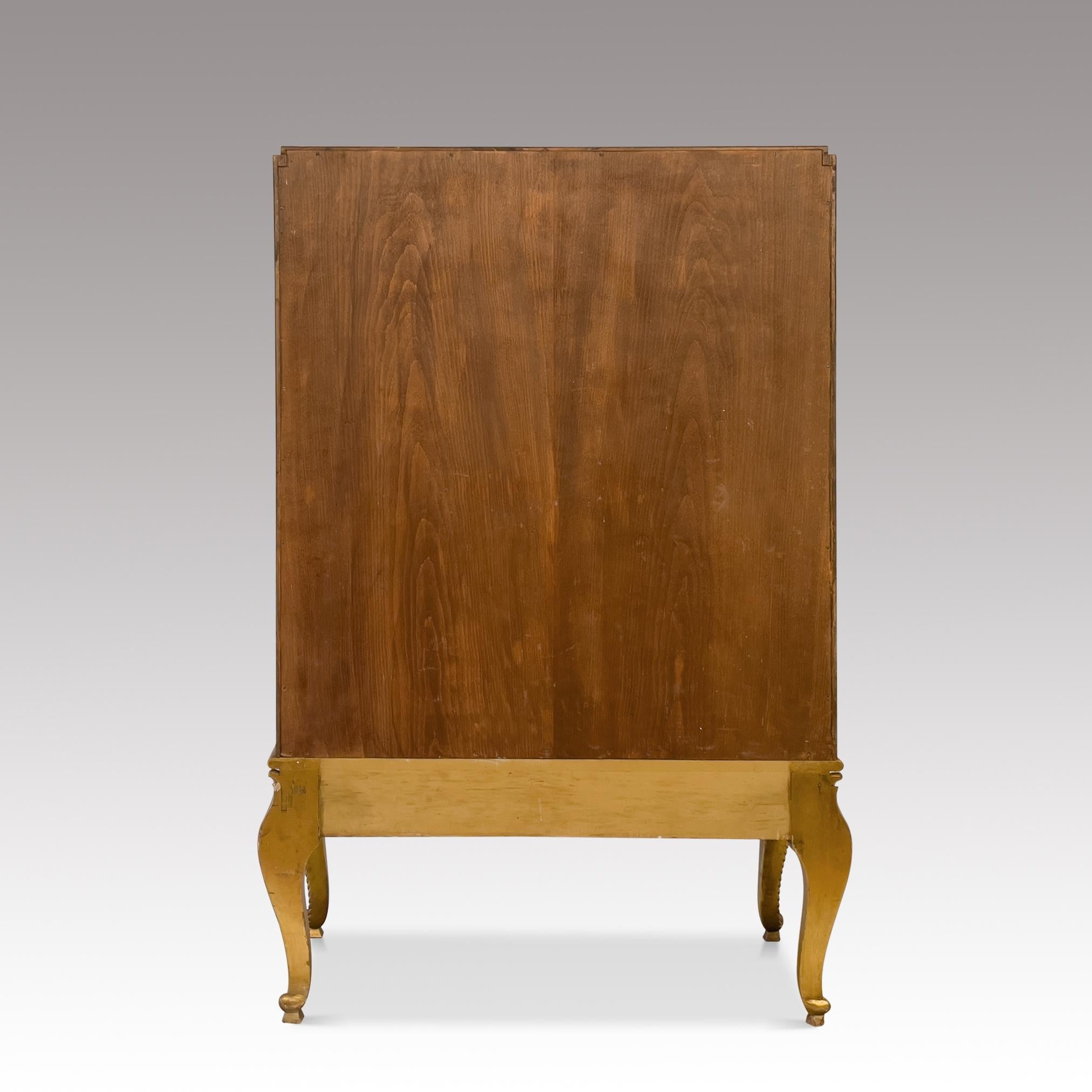 Wonderful Art Deco Cabinet designed by Maurice Dufrene and manufactured by La Maitrise around 1940. The cabinet is made from rosewood and has mother of pearl inlays.

Rosewood-veneered cabinet on carved and gilt base; folding doors with marquetry