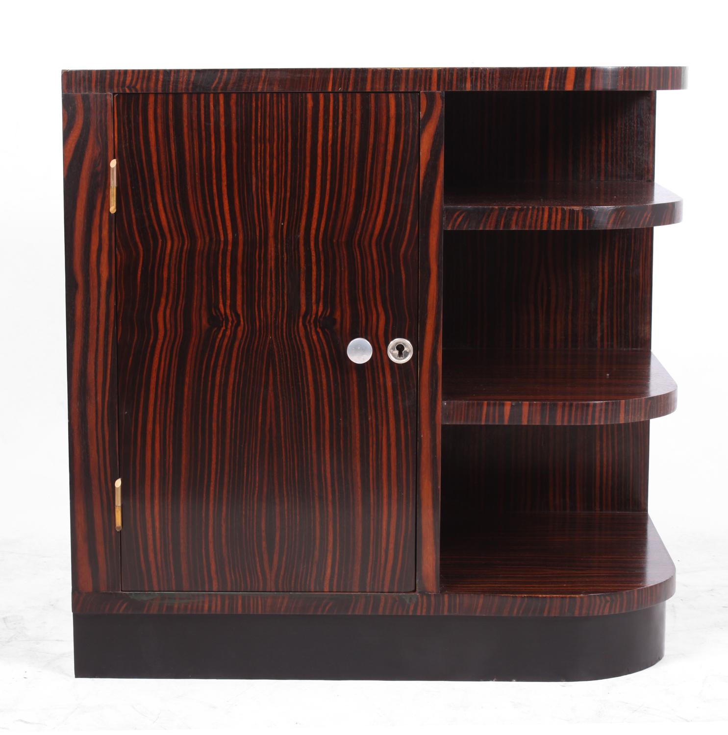 Art Deco cabinet in Macassar Ebony
A small cabinet with bookshelf to the right, originally this would have been a sofa end table as the back is also Macassar, and the left side has been ebonised, the door has a removable shelf behind the cabinet is
