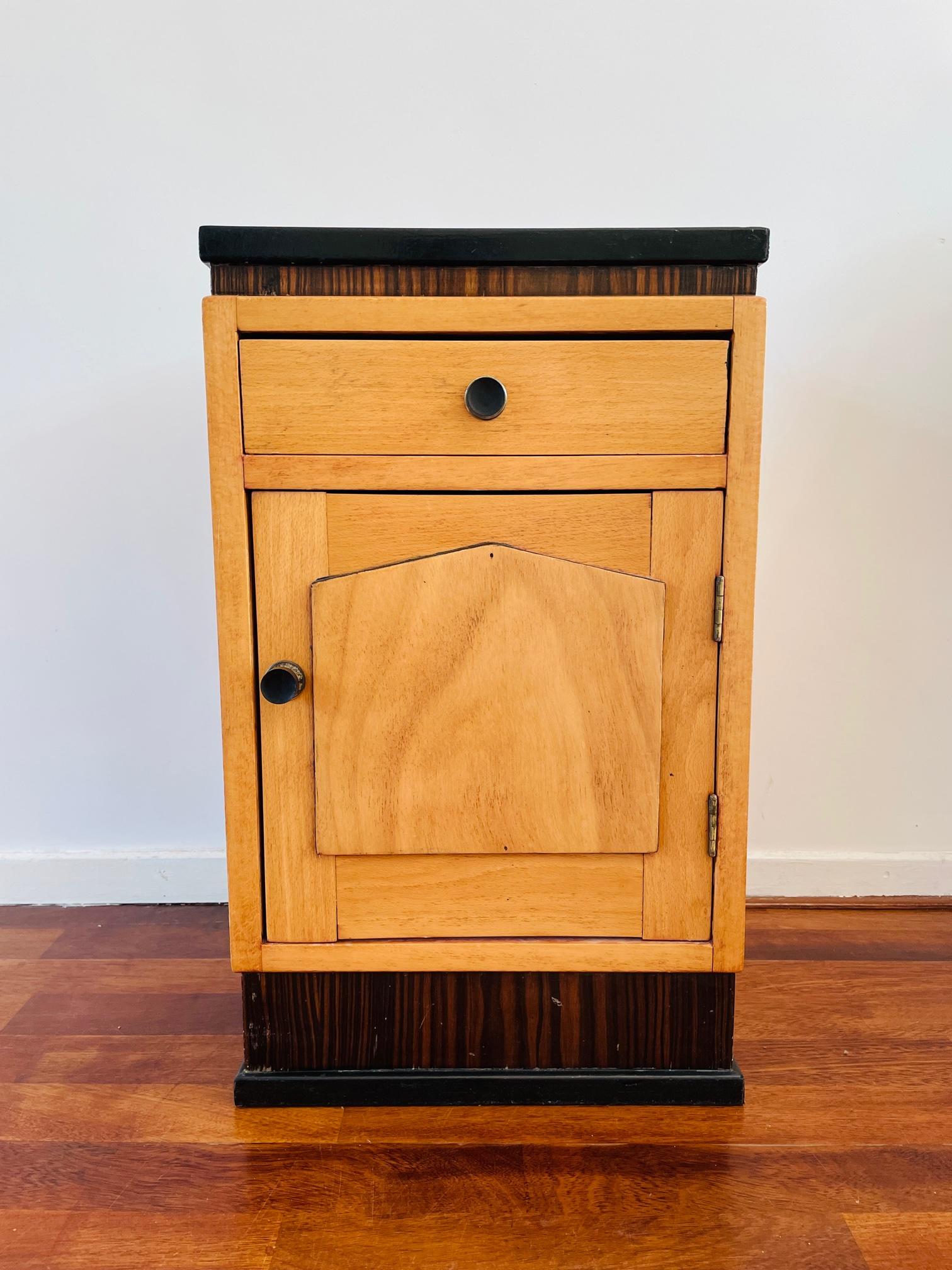 What a beautiful item. This cabinet is an eclectic piece of furniture. This small cabinet is made of different types of wood and is a beautiful mix of Art Deco and a sort of regency style. Absolutely great looking with the combination of black and
