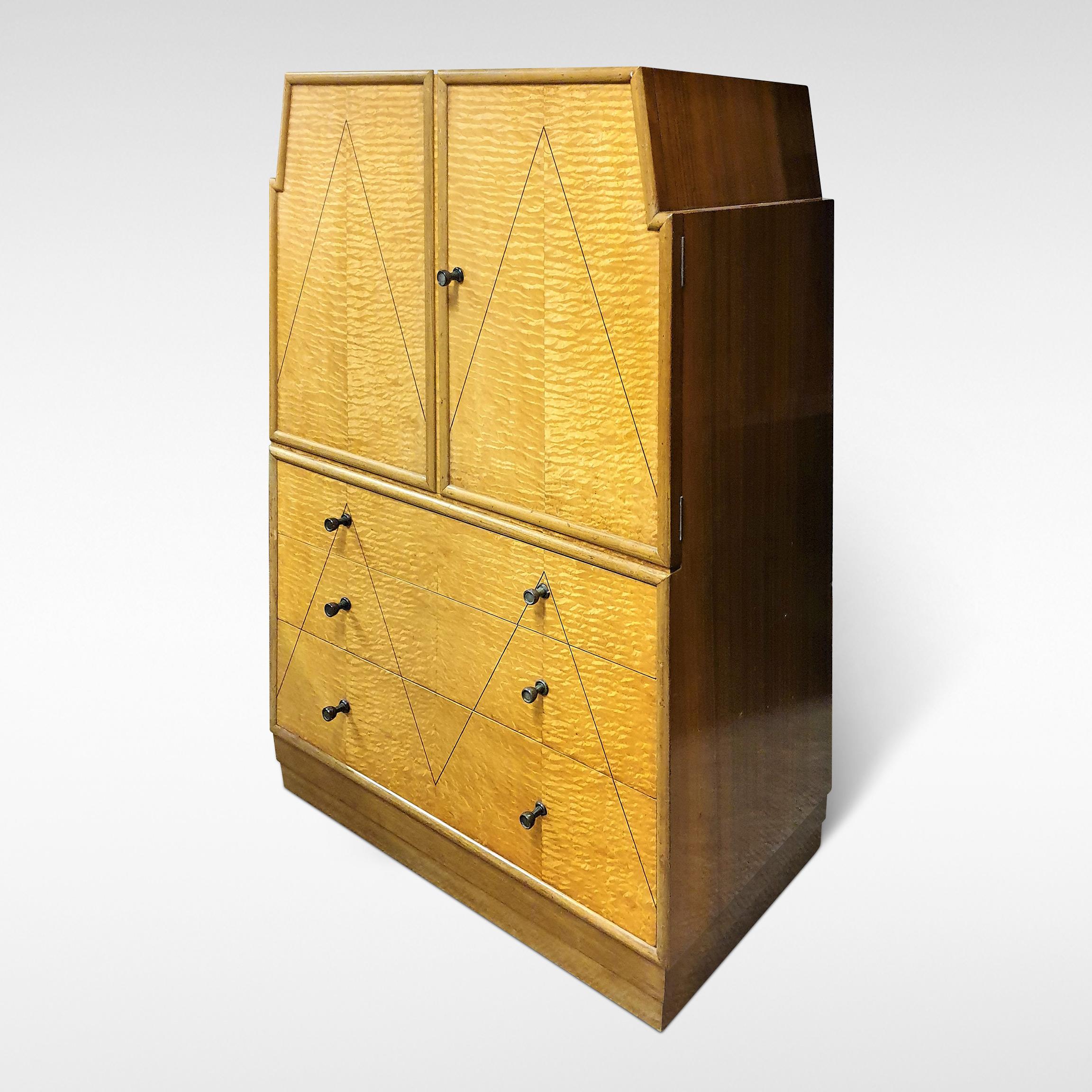 This modernist Skyscraper design cabinet with drawers from the Art Deco period is attributed to sir Ambrose heal. It has three drawers with a cupboard over in Hungarian ash veneers, with walnut to the top and sides, circa 1935.

A bedroom suite to