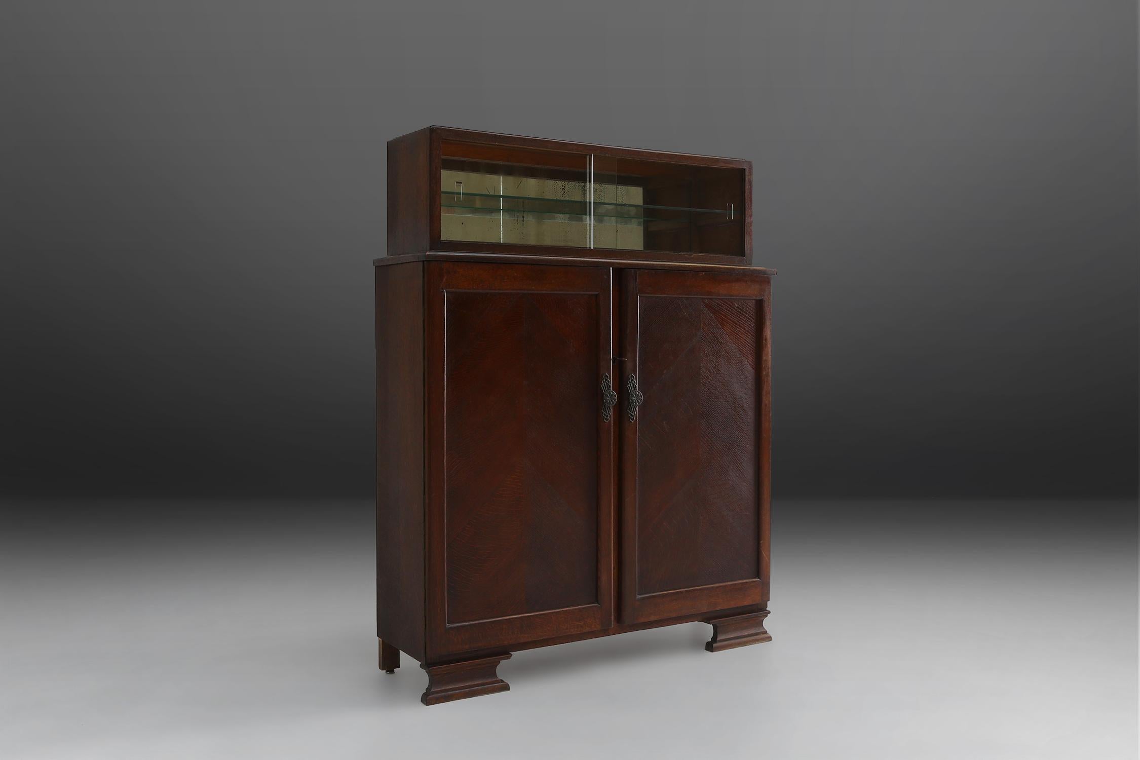 Art Deco cabinet with a vitrine on top with mirrored glass. Made of wood in the 1930s.