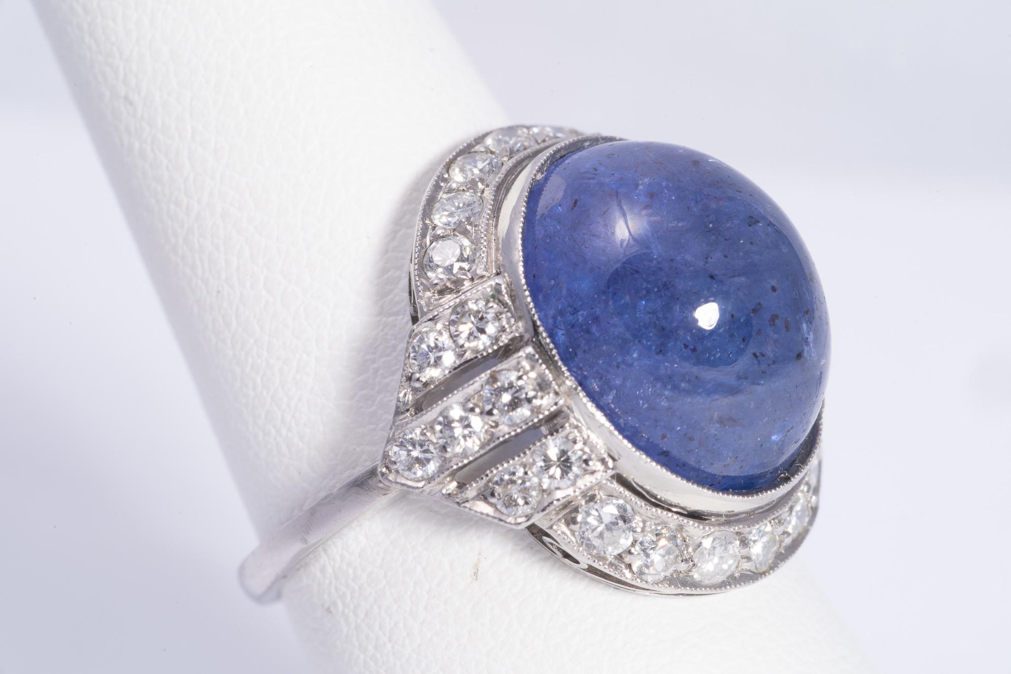 Art Deco Cabochon Sapphire and Diamond Ring.  The blue sapphire is 12.00cts and there are .65cts of diamonds around the ring. The ring is platinum and size 7.5 and can be sized. Circa. 1940.