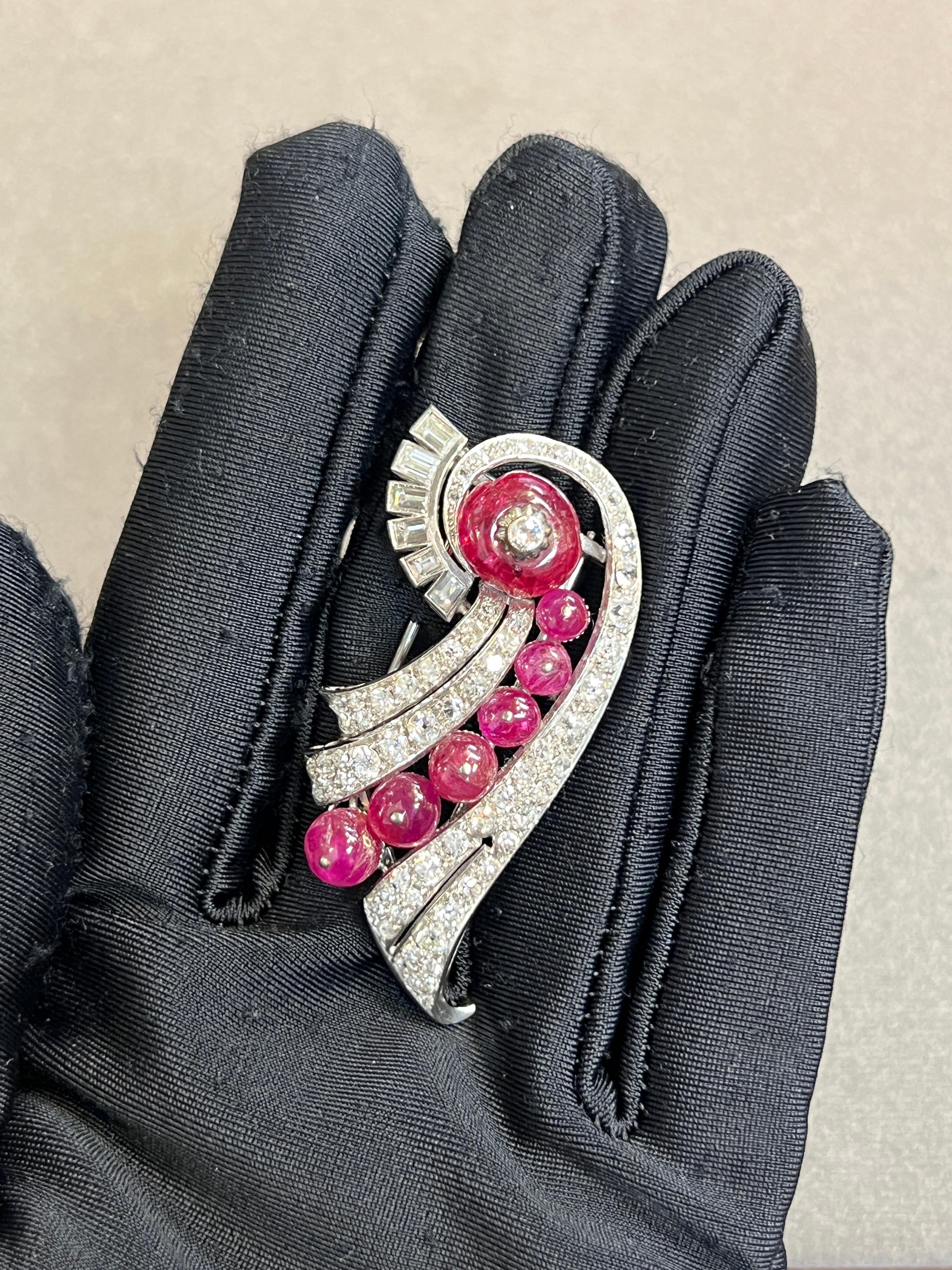 Art Deco Cabochon Ruby and Diamond Brooch

A platinum brooch set with cabochon rubies and baguette and round cut diamonds. 

Circa 1930 
Approximate Diamond Weight: 4.26 carats
Approximate Length: 2 inches
Metal Type: Platinum