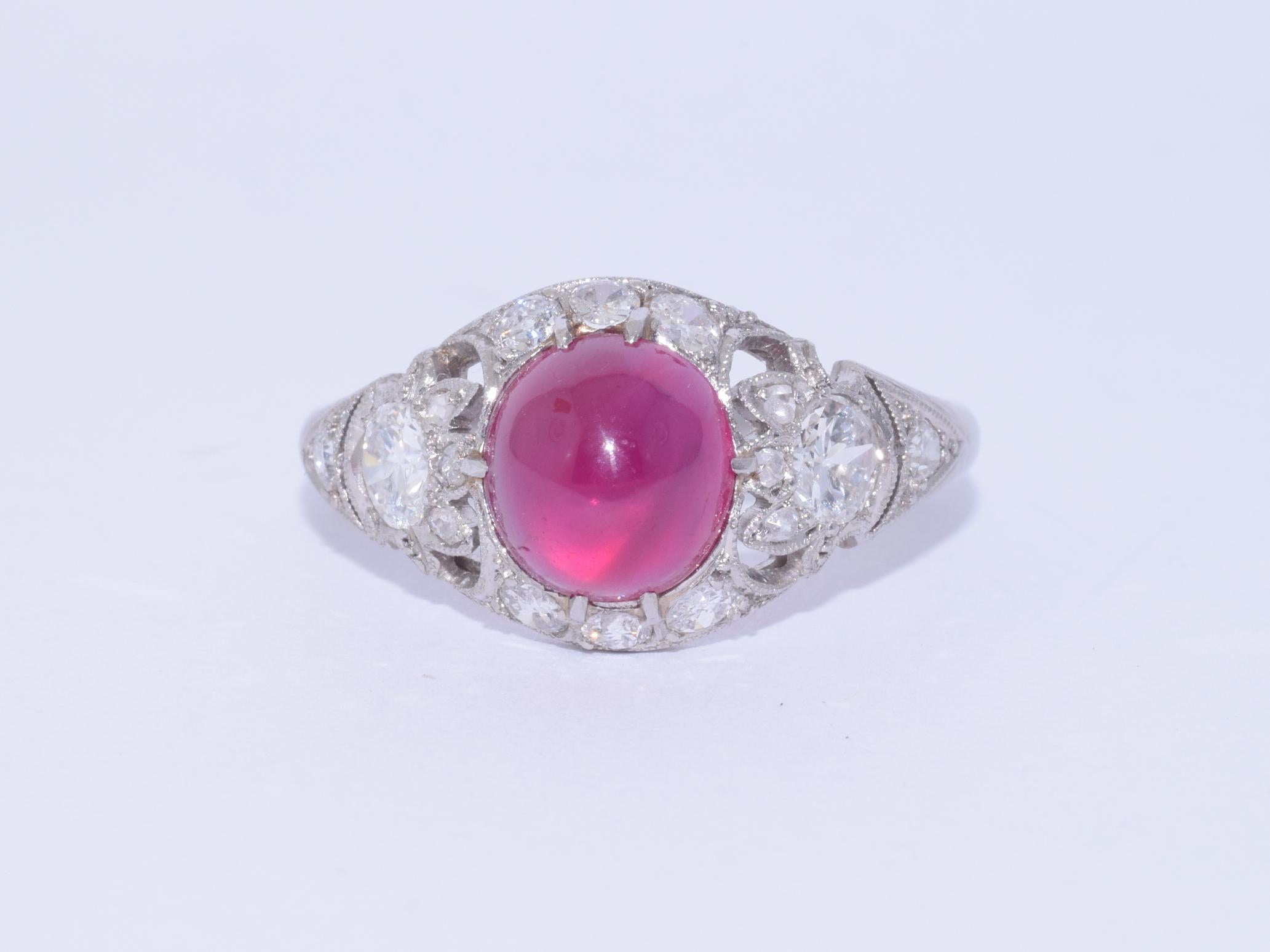 A cabochon ruby weighing approximately 3 carats is set in a platinum mounting accented with old European, round and rose cut diamonds totaling approximately 0.40 carat. Circa 1920s. The head of the ring measures approximately 10.8 x 19.7mm, height