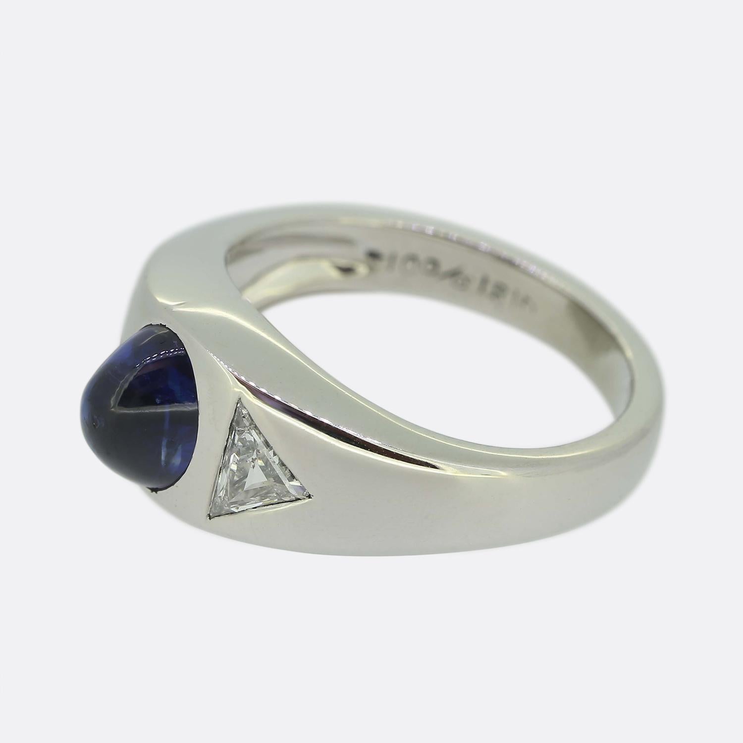 Here we have a sensational sapphire and diamond three-stone ring. Crafted from platinum, this Art Deco ring features a cabochon sapphire and two trilliant cut diamonds.

Condition: Used (Excellent)
Weight: 7.0 grams
Ring Size: I (48)
Band Width: 8mm