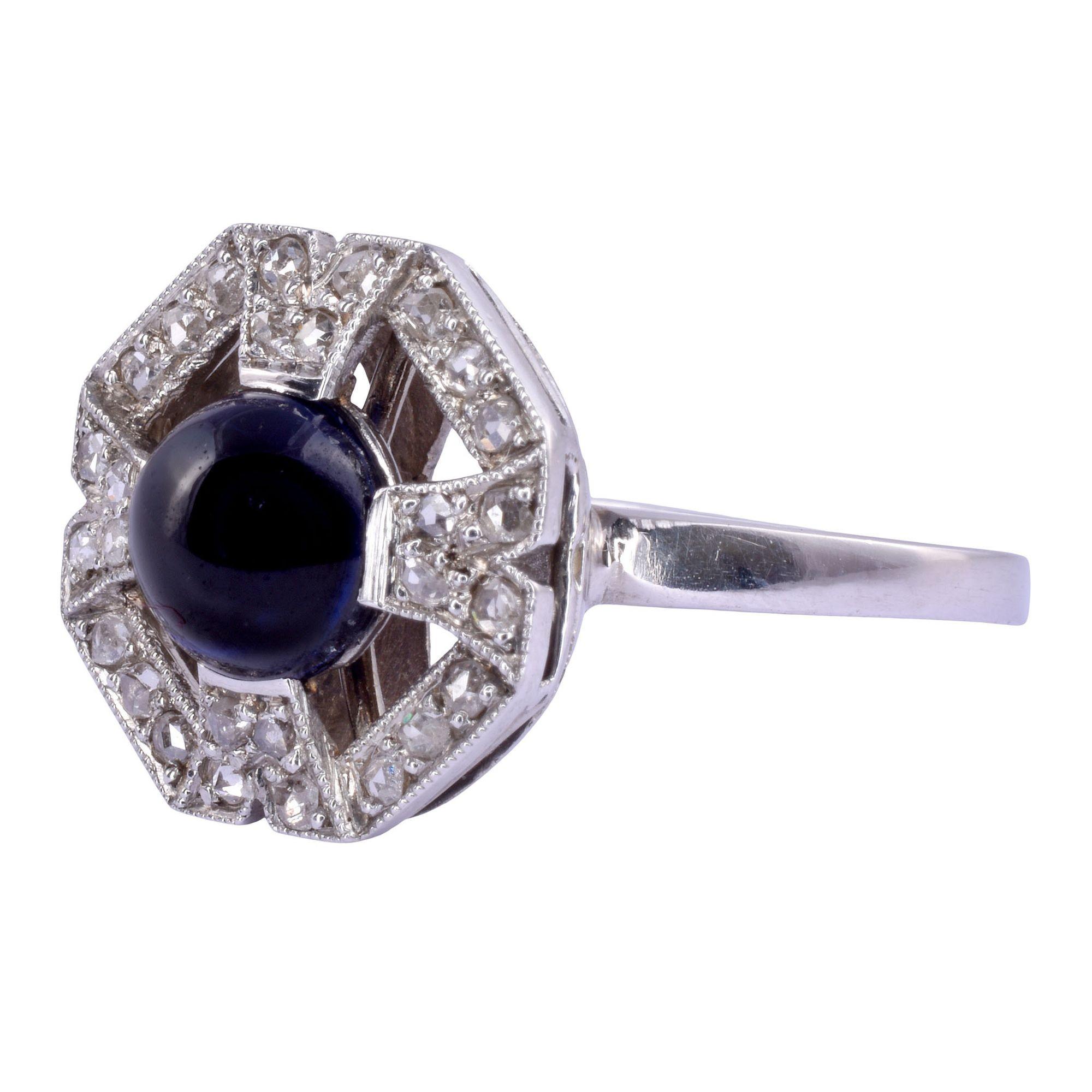 Antique Art Deco cabochon sapphire & diamond platinum ring, circa 1920. This Art Deco ring is crafted in platinum and features a cabochon sapphire at approximately 1.90 carats, note small chip at 2 o’clock position. There are 28 rose cut accent