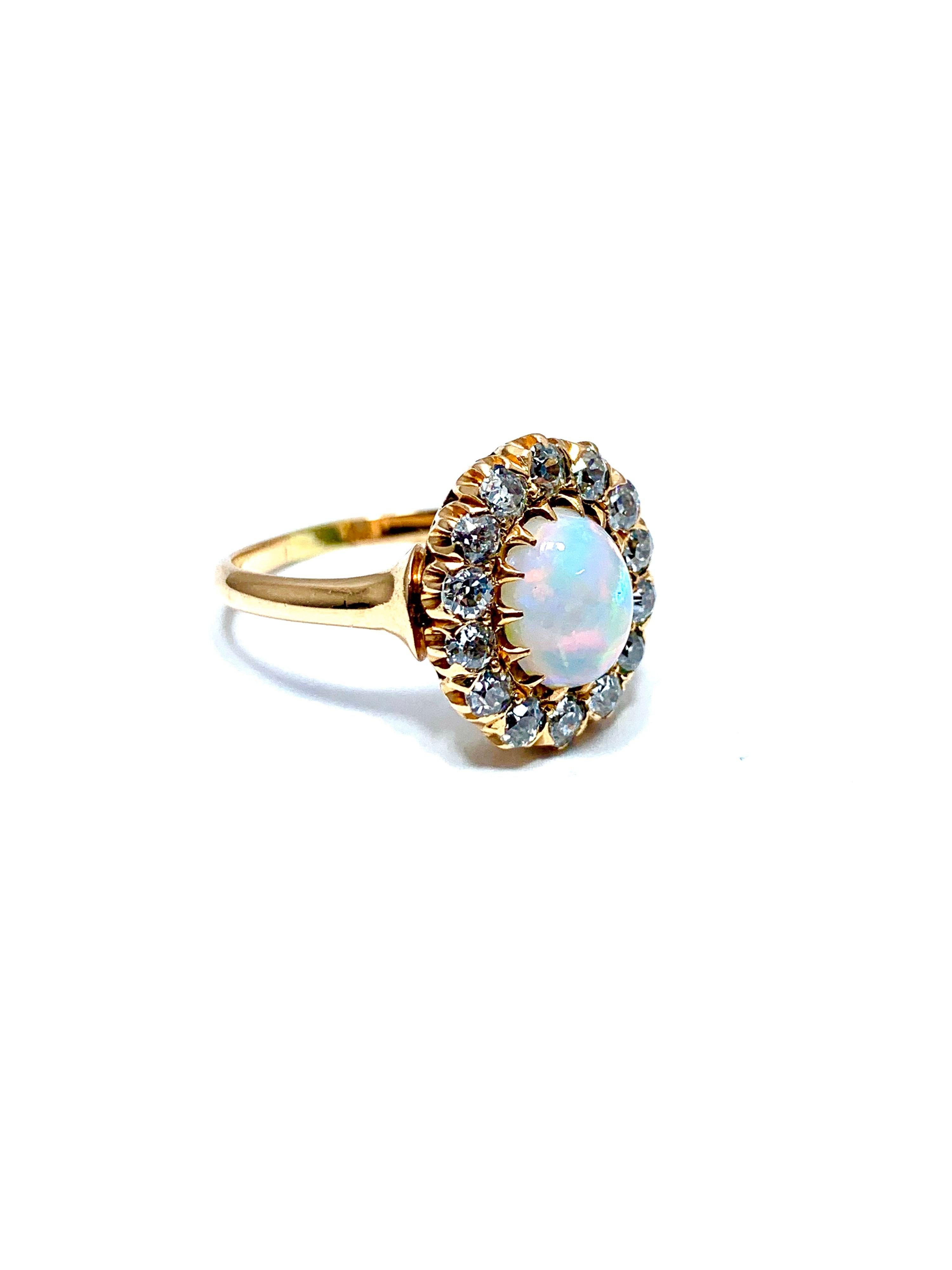 A simply beautiful Art Deco Style cabochon white opal and Diamond 14k rose gold cocktail ring.  The opal is 8.40 x 6.70mm, and displays gorgeous play of color in every color.  the Opal is prong set with a single row of old European cut Diamonds