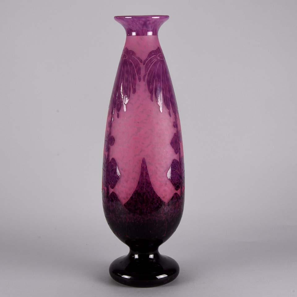 Impressive early 20th century Art Deco glass vase of slender form etched with vibrant pink and purple stylised Art Deco Dahlia motifs against a pale pink background with excellent color and detail, signed Le Verre Français.