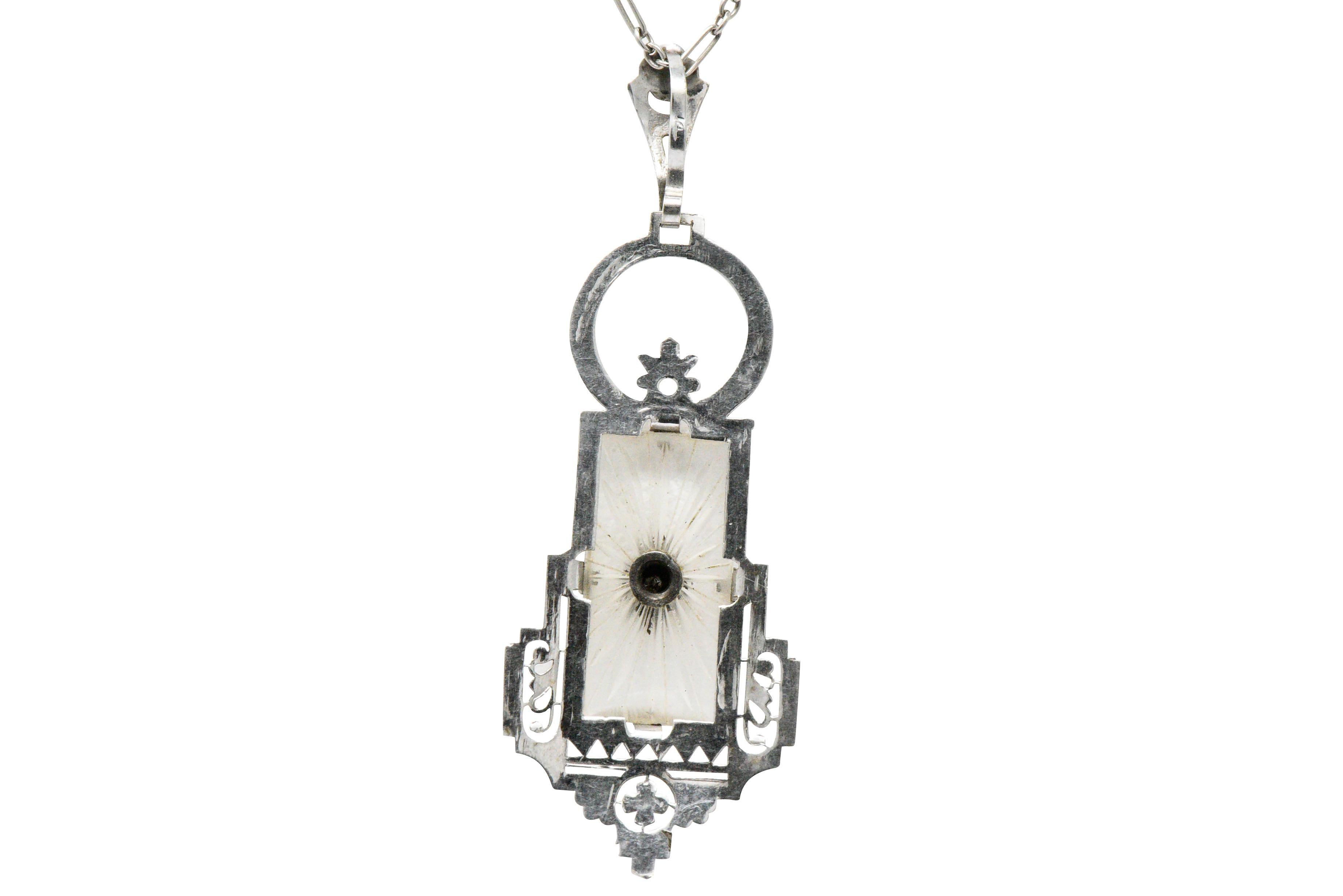Pendant centering square carved camphor glass with inset single cut diamond weighing approximately 0.015 carats total

With a geometric and folate motif with hand engraved details

On an elongated cable chain

Pendant Length: Approx. 2 inches

Chain