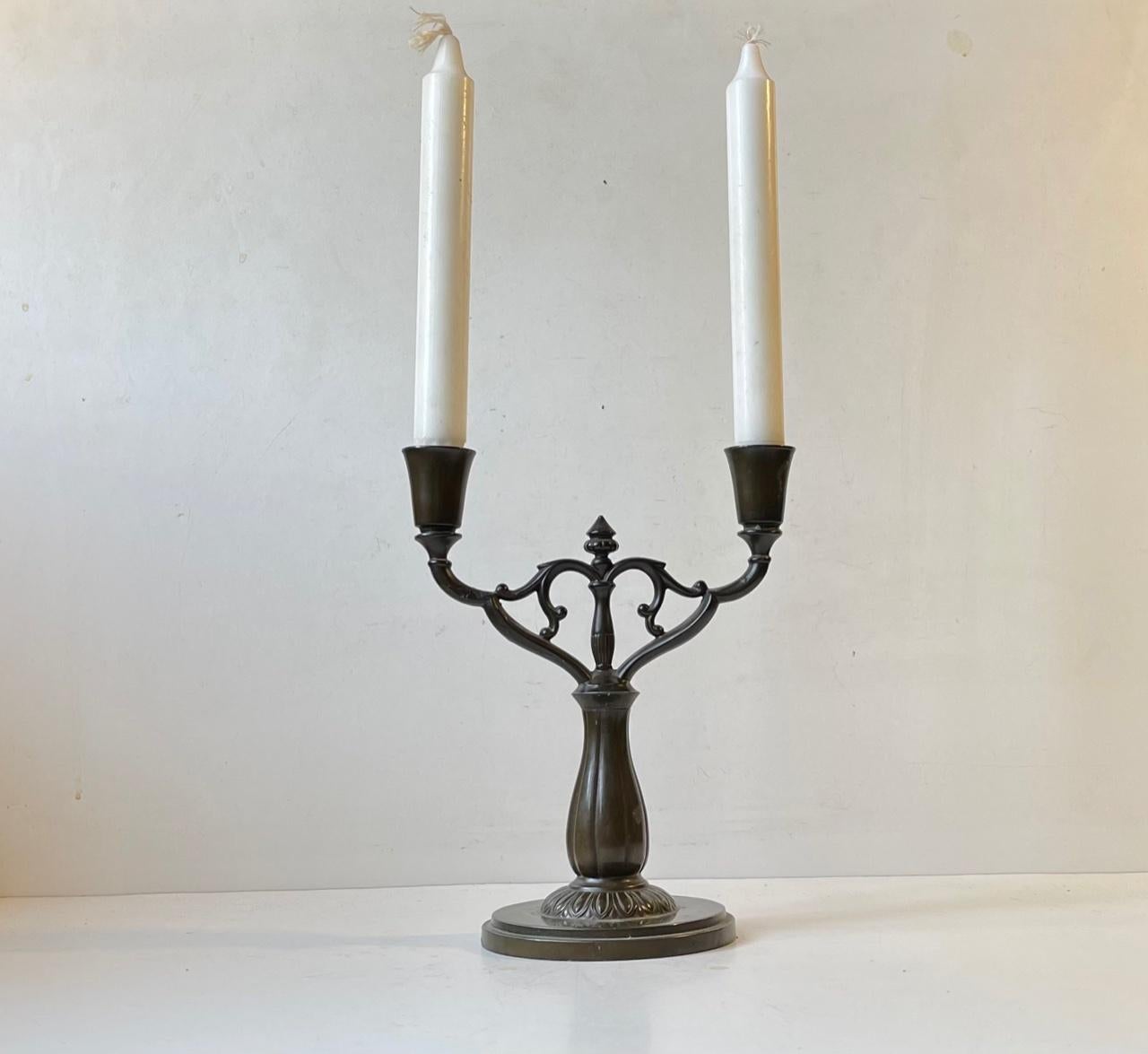 Large candelabra in disko metal by Just Andersen. Manufactured during the 1930s in his workshop in Copenhagen. This is design/model 74 and it features an architecturally fluted stem and 'stained' base. Its stamped and numbered by the maker to the