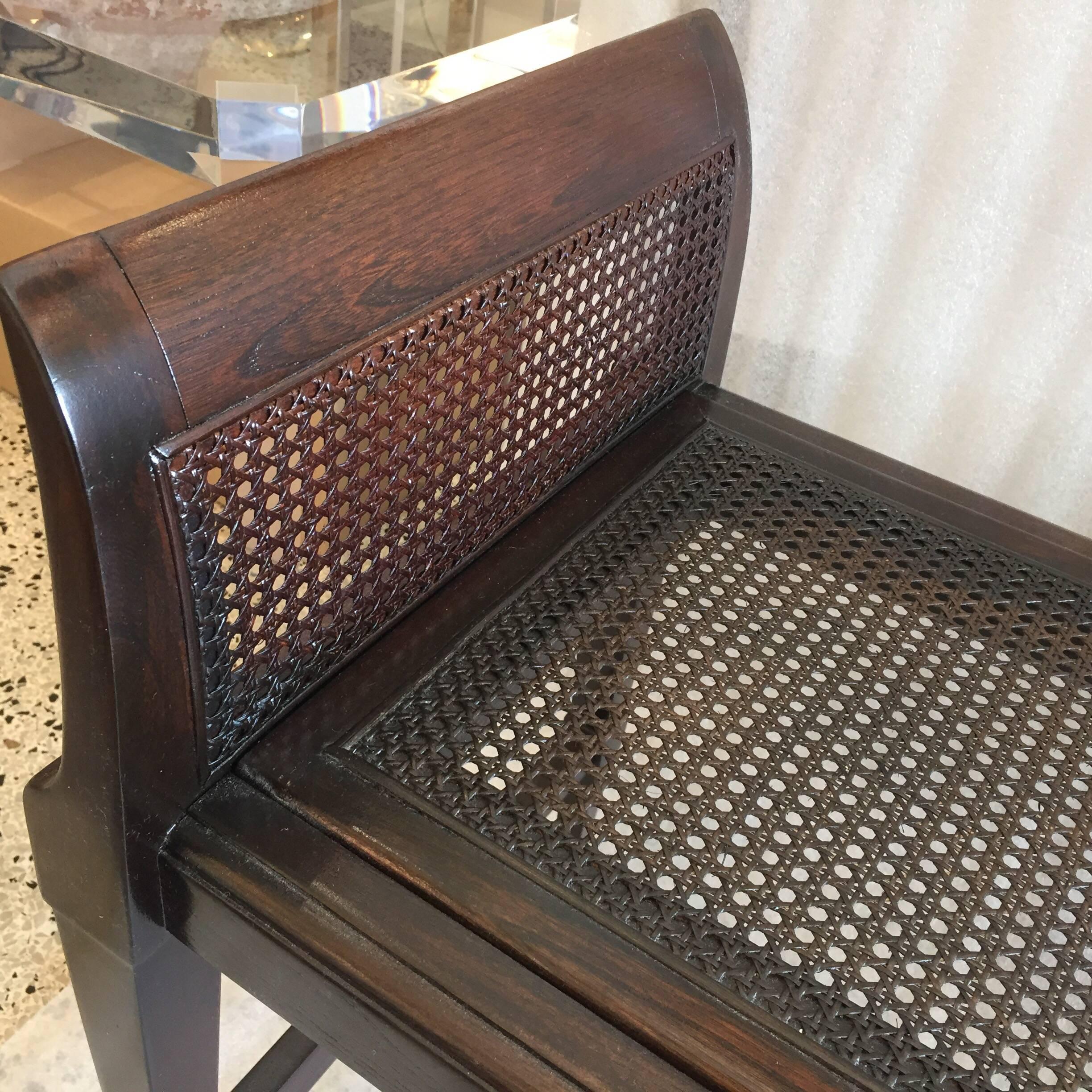 This is an amazing bench with so many details to enjoy. The rich dark stain is very clean and without issue, the cane sides and seat are strong and no breaks. The feet and stretcher are Art Deco treasures. See all detail images.