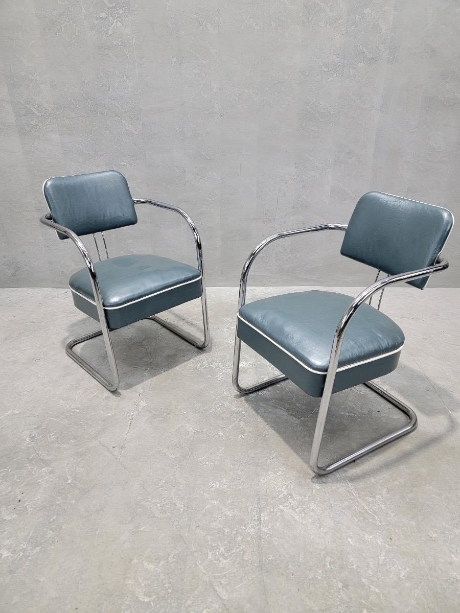 Art Deco Cantilever Chairs Attributed to Kem Weber for Lloyd’s Manufacturing Newly Upholstered in Holly Hunt Teal Metallic Full Grain Leather with White Trim - Pair 

Enhance your living space with these exquisite art deco cantilever chairs