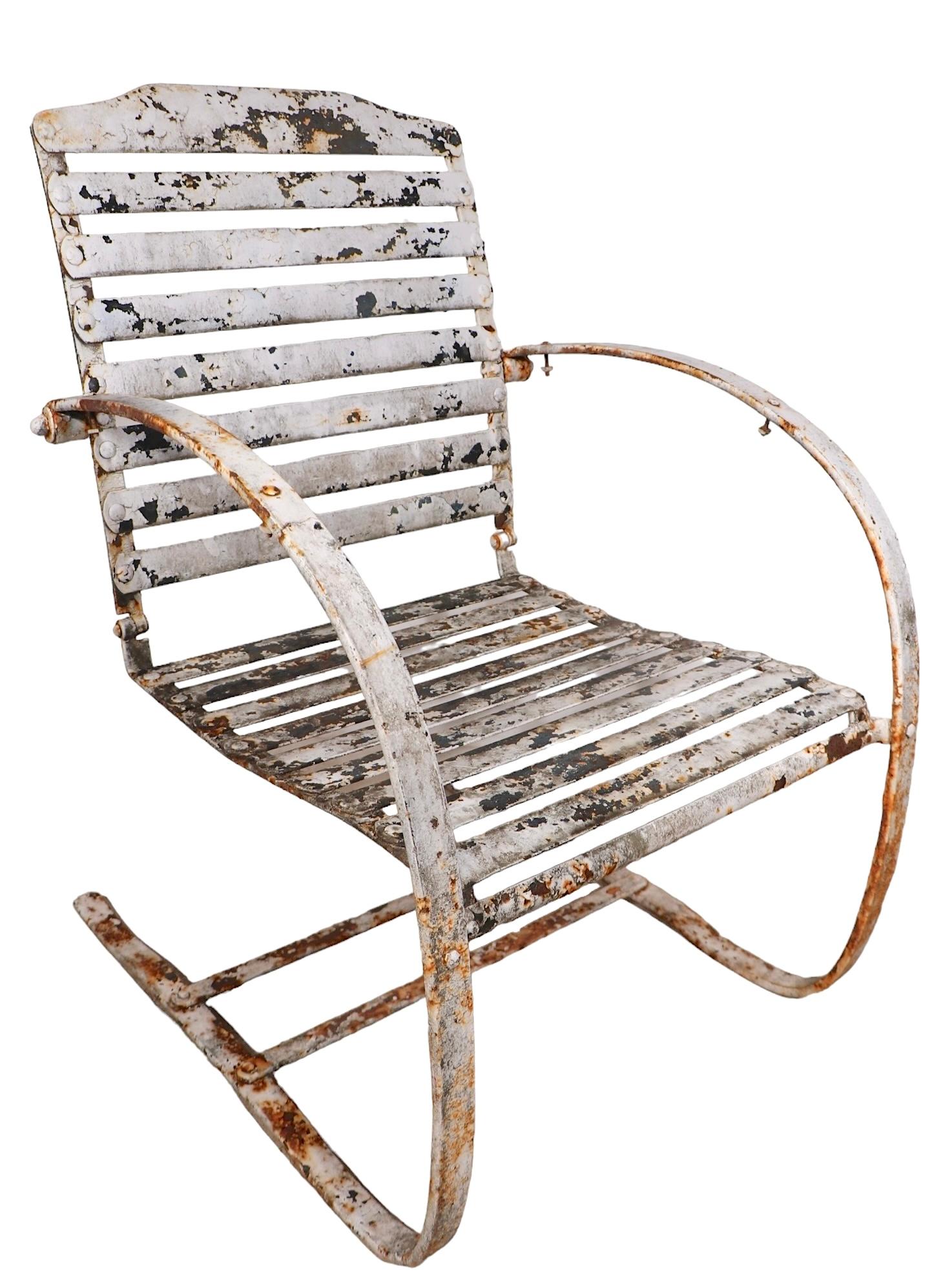 Chic Art Deco  cantilevered spring chair in iron and  wrought iron, attributed to The Cincinnati Artistic Iron Works Company, circa 1930. The chair is structurally sound and sturdy, the surface is in peely white paint finish, which shows obvious
