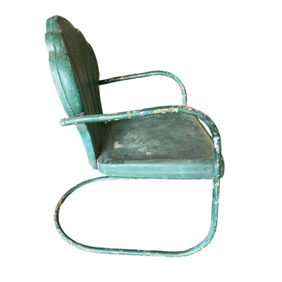 Art Deco steel metal clamshell back green patio bouncer lounge chair featuring a distressed green painted finish, 