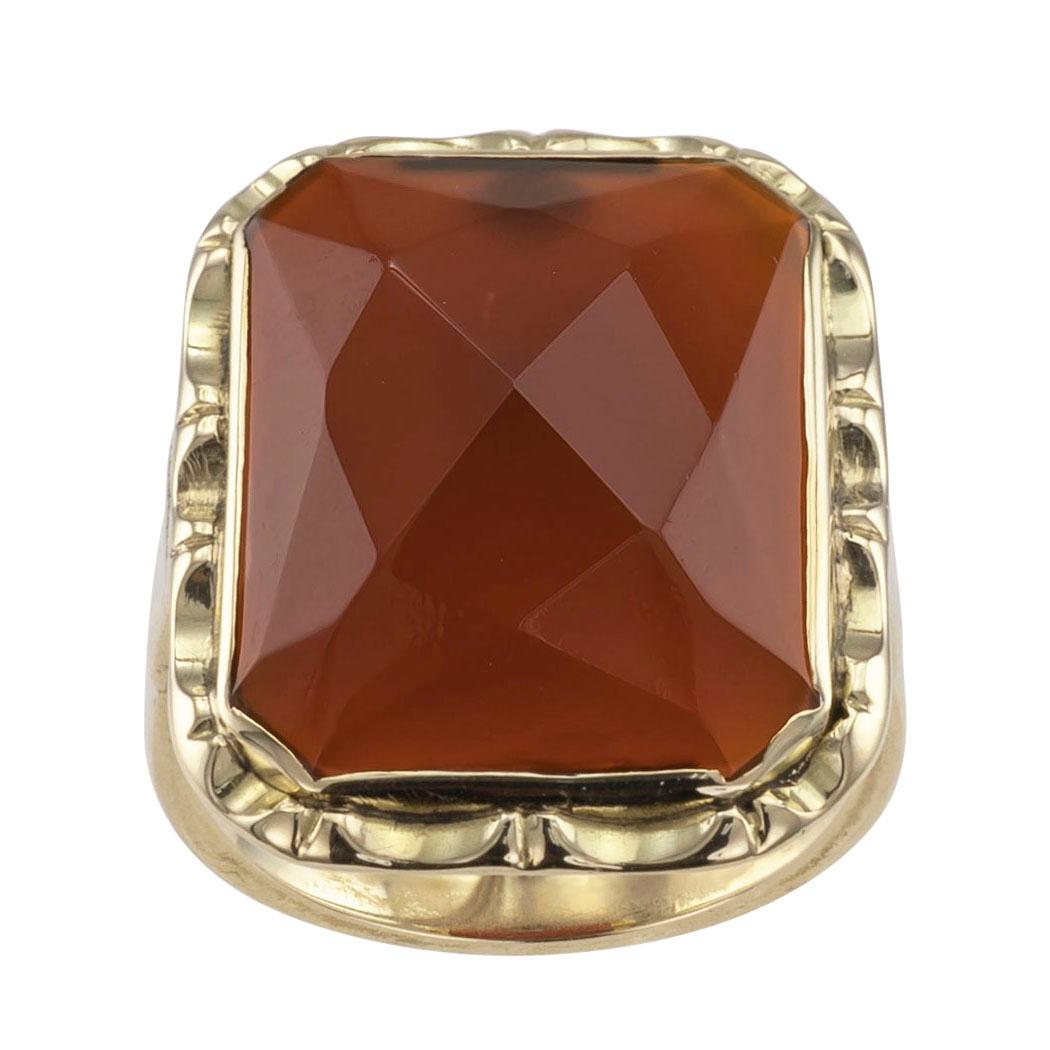 Art Deco carnelian and gold ring circa 1930. The design showcases a slightly domed, rectangular carnelian with rose-cut faceting, bezel-set to the simple shank. The faceting pattern of the stone catches and reflects light in a very attractive manner