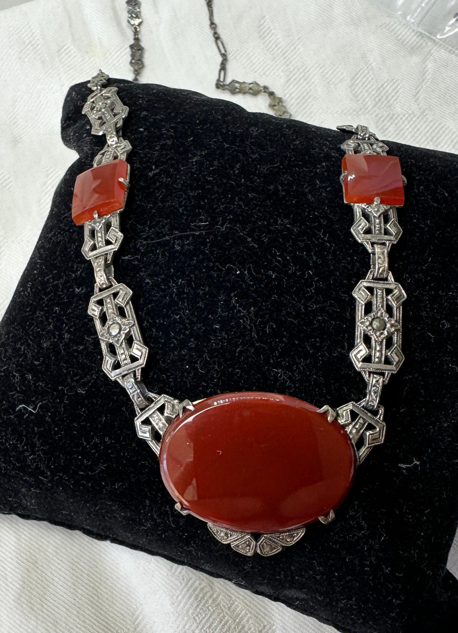 THIS IS A STUNNING ORIGINAL ART DECO CARNELIAN MARCASITE NECKLACE OF THE FINEST QUALITY.  THE NECKLACE IS SET WITH THREE OVAL AND SQUARE CUT GORGEOUS VIVID CARNELIAN STONES SET IN STERLING SILVER WITH MARCASITES IN THIS CLASSIC ART DECO JEWEL.  
It