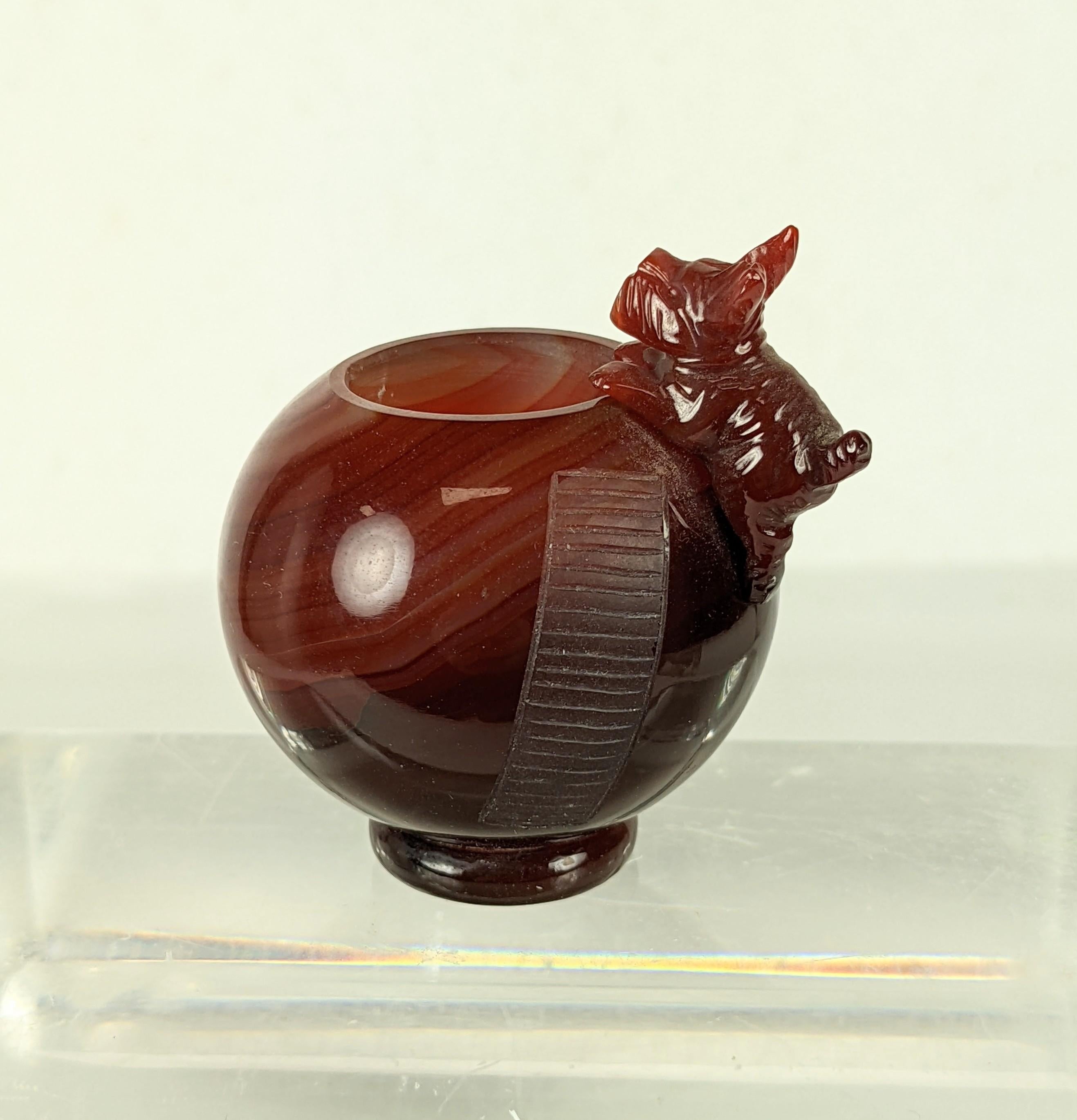Charming hand carved Art Deco Carnelian Match Holder with a terrier climbing up a sphere. A faux ladder is carved into the stone and becomes the 