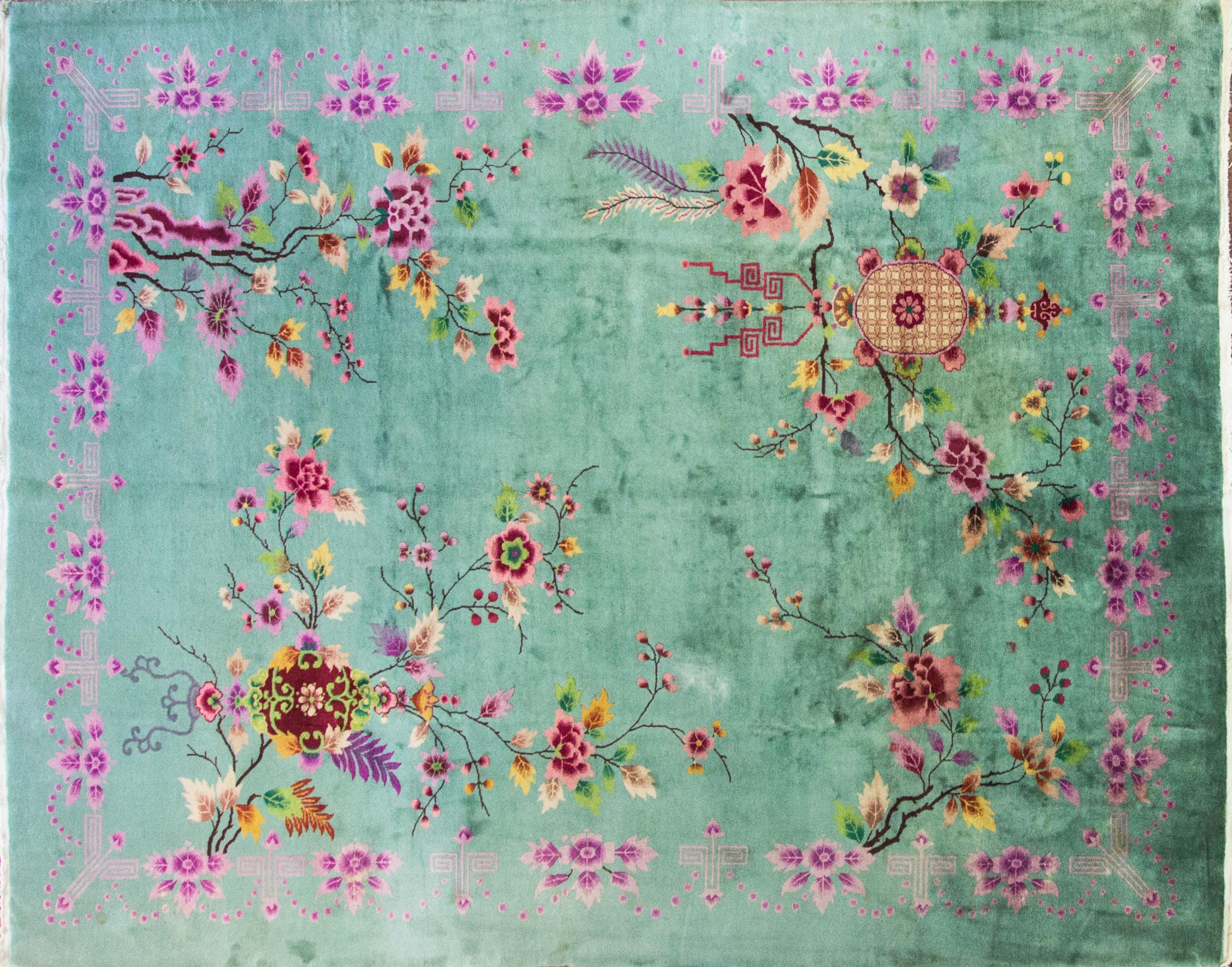 Soft jade green background with beautiful floral design.
 The Art Deco period was an international design movement from 1920s-1940s.
Art Deco rugs are characterized by experimentation with bold colors, angular lines, and the omission of heavy