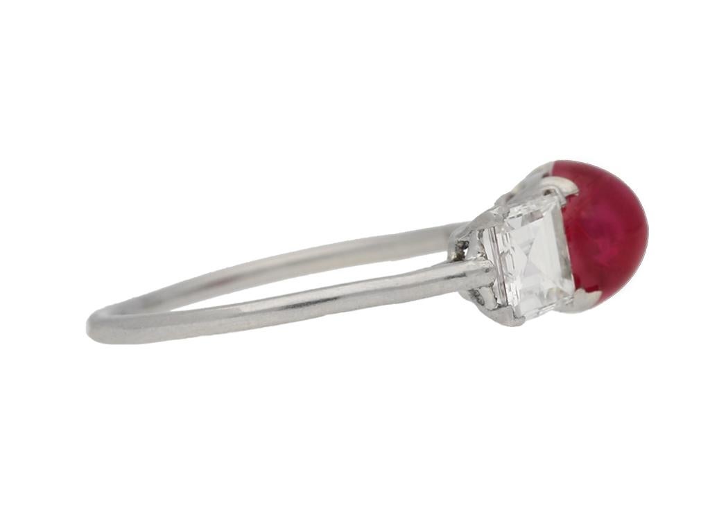 Art Deco Cartier cabochon Burmese ruby and diamond ring. Set with an oval cabochon natural unenhanced Burmese ruby in an open back claw setting with an approximate weight of 1.80 carats, further set with two square baguette cut diamonds in open back