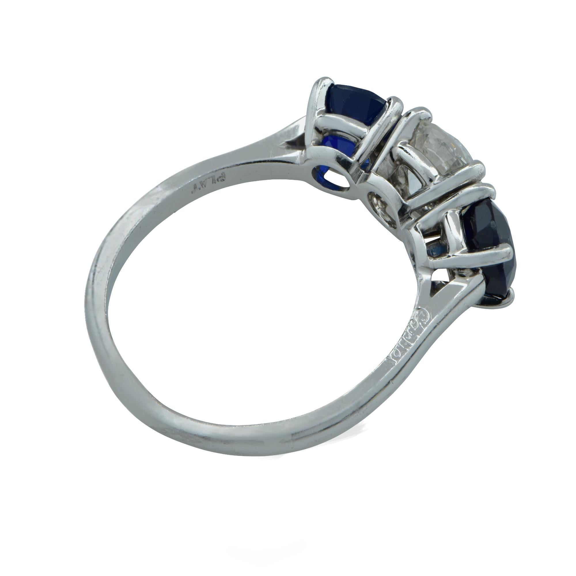 pectacular Cartier Art Deco diamond and sapphire three stone ring elegantly crafted in platinum. This stunning ring exemplifies Cartier’s craftsmanship boasting a stunning European Cut diamond weighing approximately 1.05 carats, G color, VS2