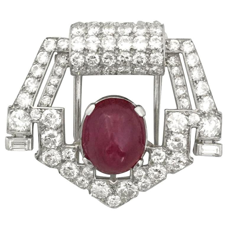 Platinum Art Deco Cartier brooch, set with old mine cut diamonds, single cut diamonds and two baguette-cut diamonds, the center is decorated with a slight pinkish-red color cabochon ruby with some external natural cracks at the surface. Have a