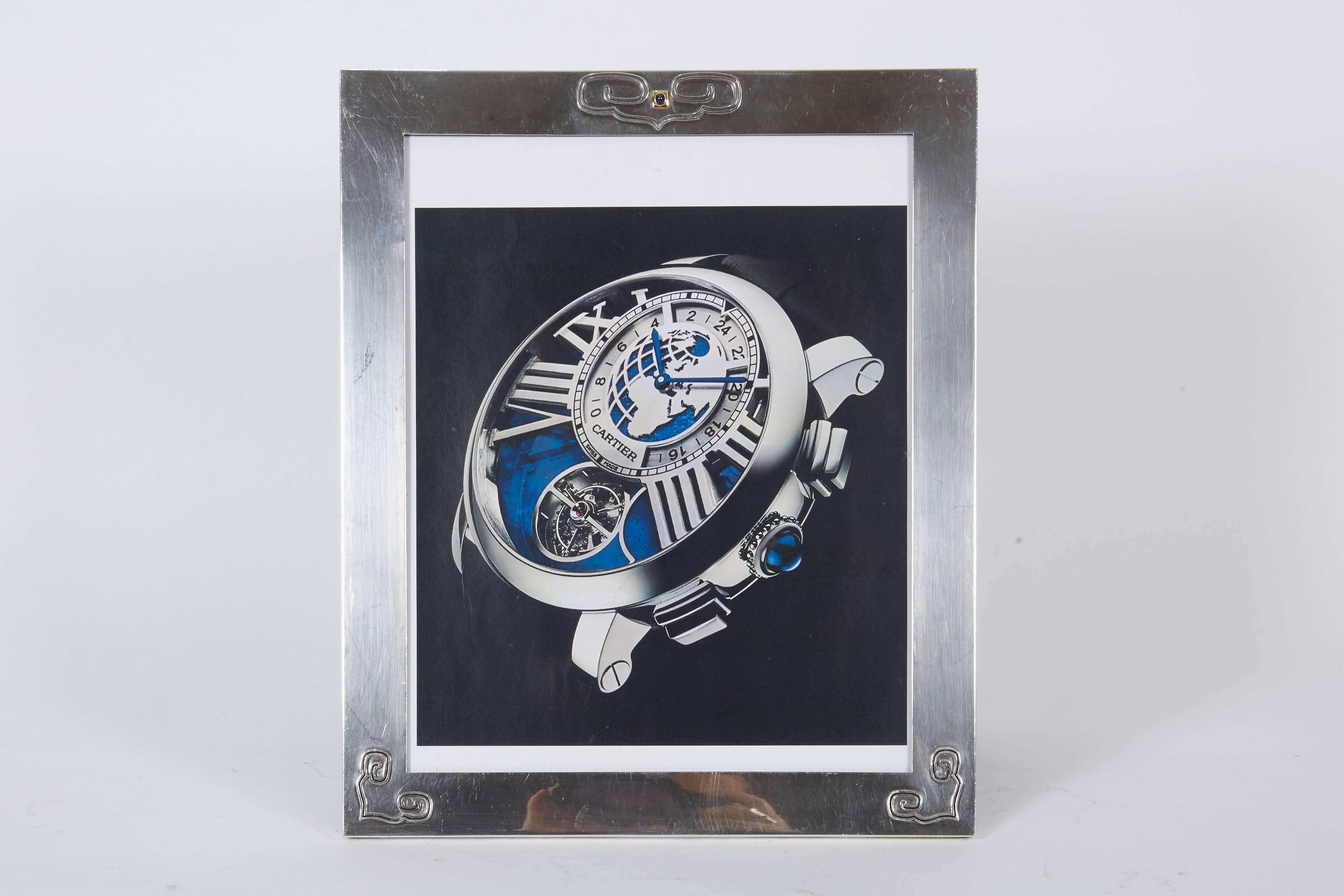 Art Deco Cartier sterling silver and gold picture photo frame with cabochon sapphire.

Frame measures 10