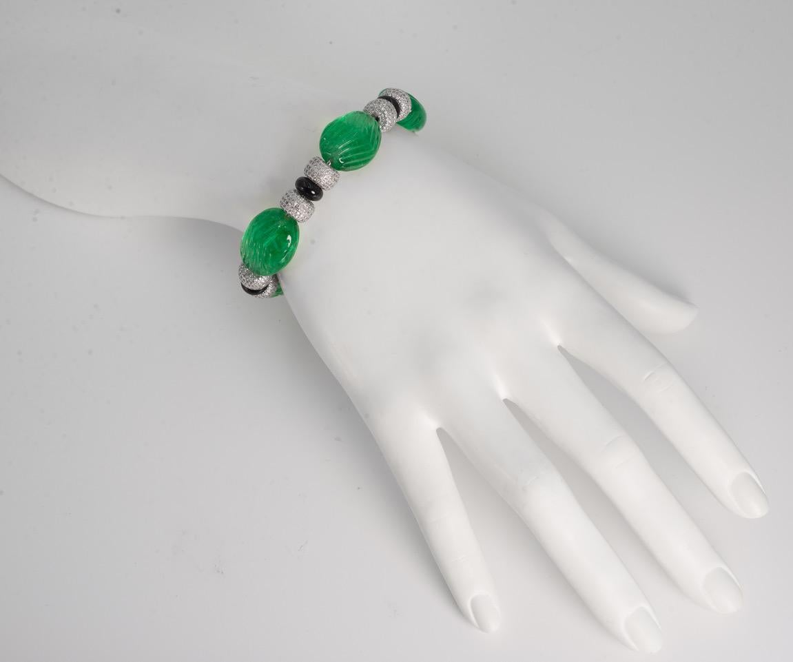 Art Deco Cartier Style Carved Emerald Diamond Onyx Bracelet
From our exclusive one-of-a-kind costume jewellery collection replicating the finest collectable estate jewels of a glamourous past. The bracelet is made with Art Deco faux-carved emeralds