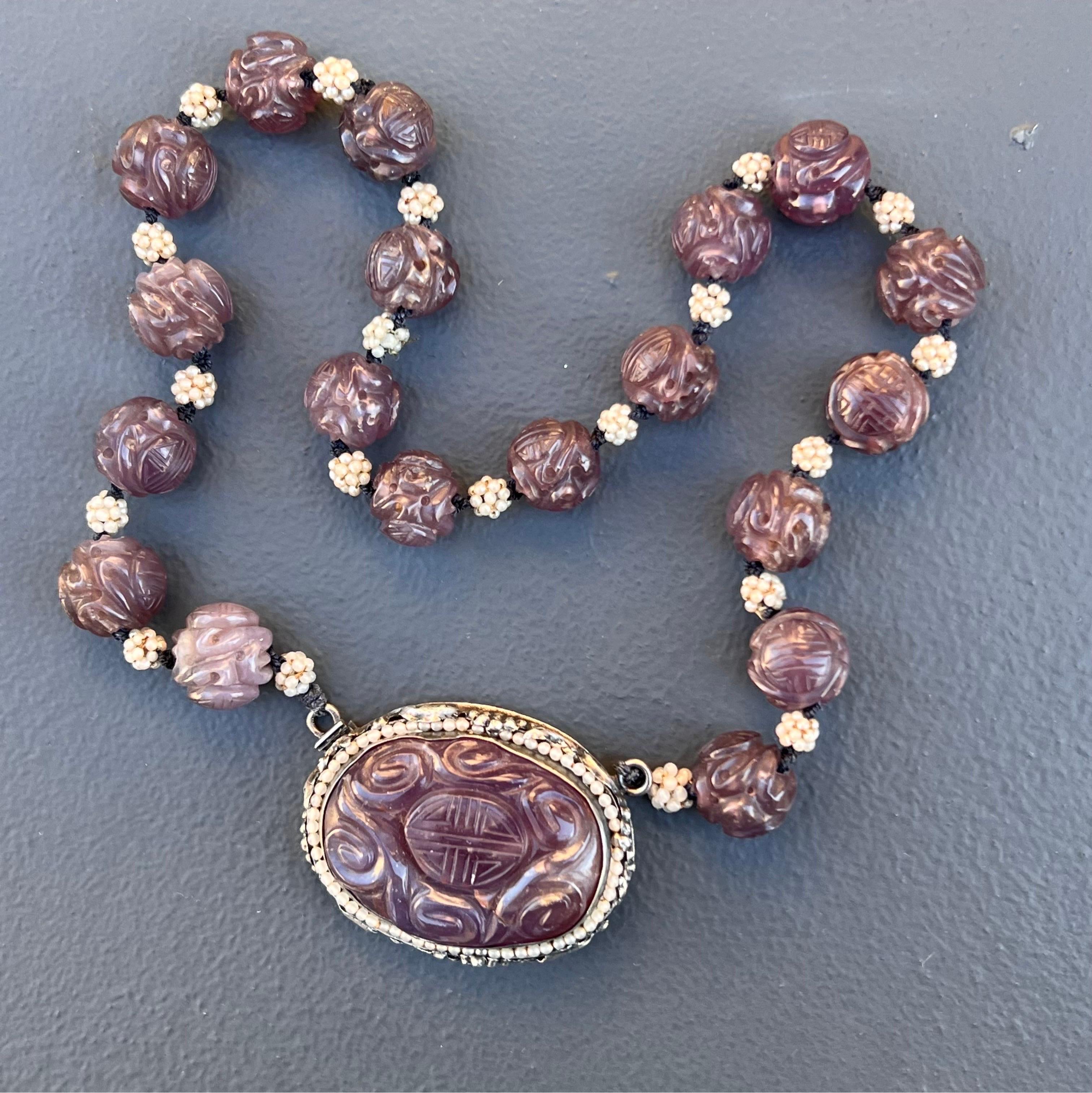 Antique handmade  Art Deco Chinese export  necklace with carved Shou amethyst beads with a large very ornate sterling silver clasp . Clasp /central pendant has deeply carved amethyst stone which is set on an very ornate frame featuring different