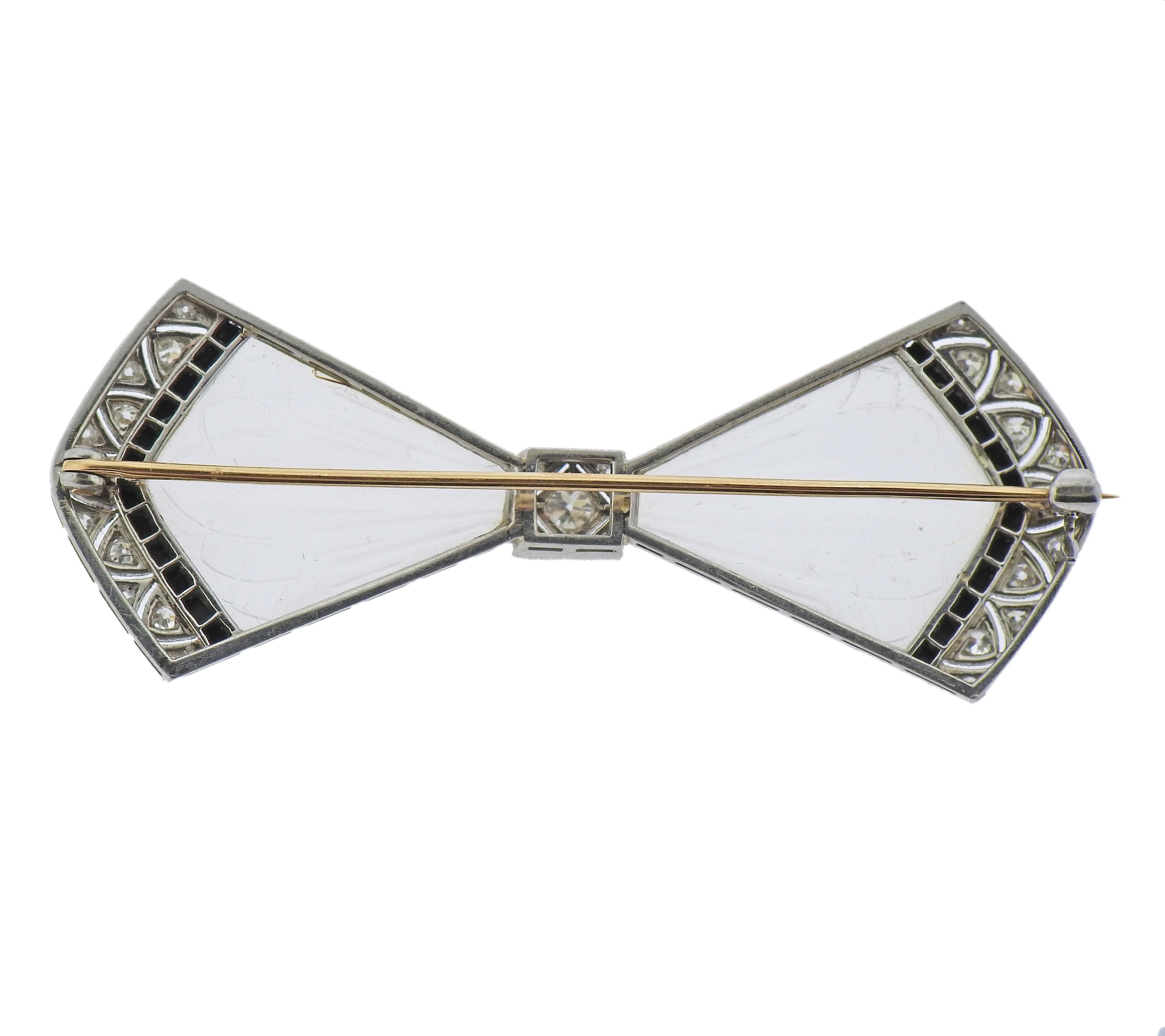 Art Deco platinum top and 14k gold hardware bow brooch, adorned with carved frosted crystal, onyx accents and approx. 0.44ctw in diamonds. Brooch measures 2 3/8