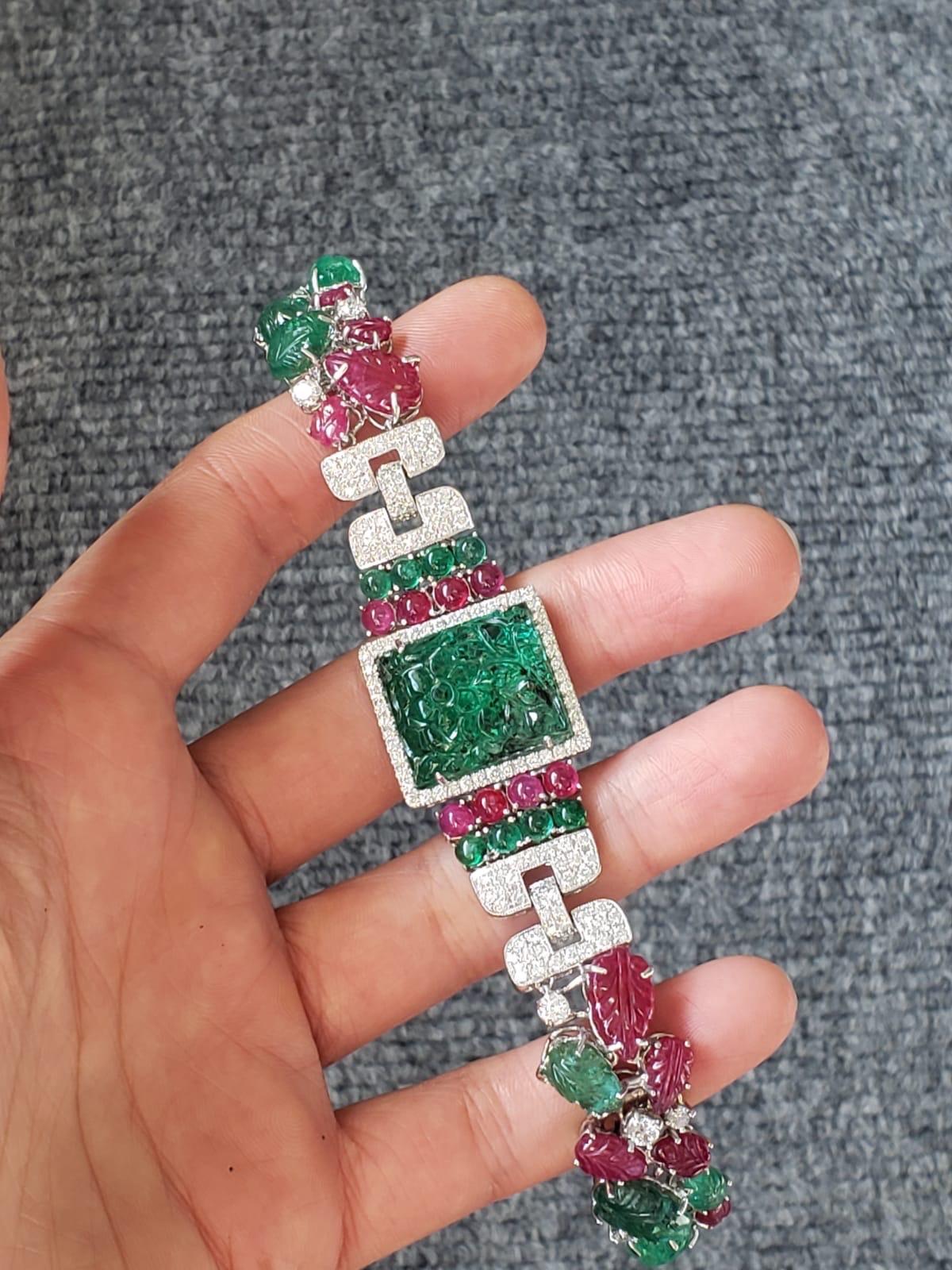 A beautiful, Art-Deco Style Tutti Frutti bracelet. The bracelet comprises of natural Zambian Emeralds and Burmese Rubies and Diamonds all set in 18K White Gold. The bracelet is extremely flexible, currently it is 7.5 inches long, and can be adjusted