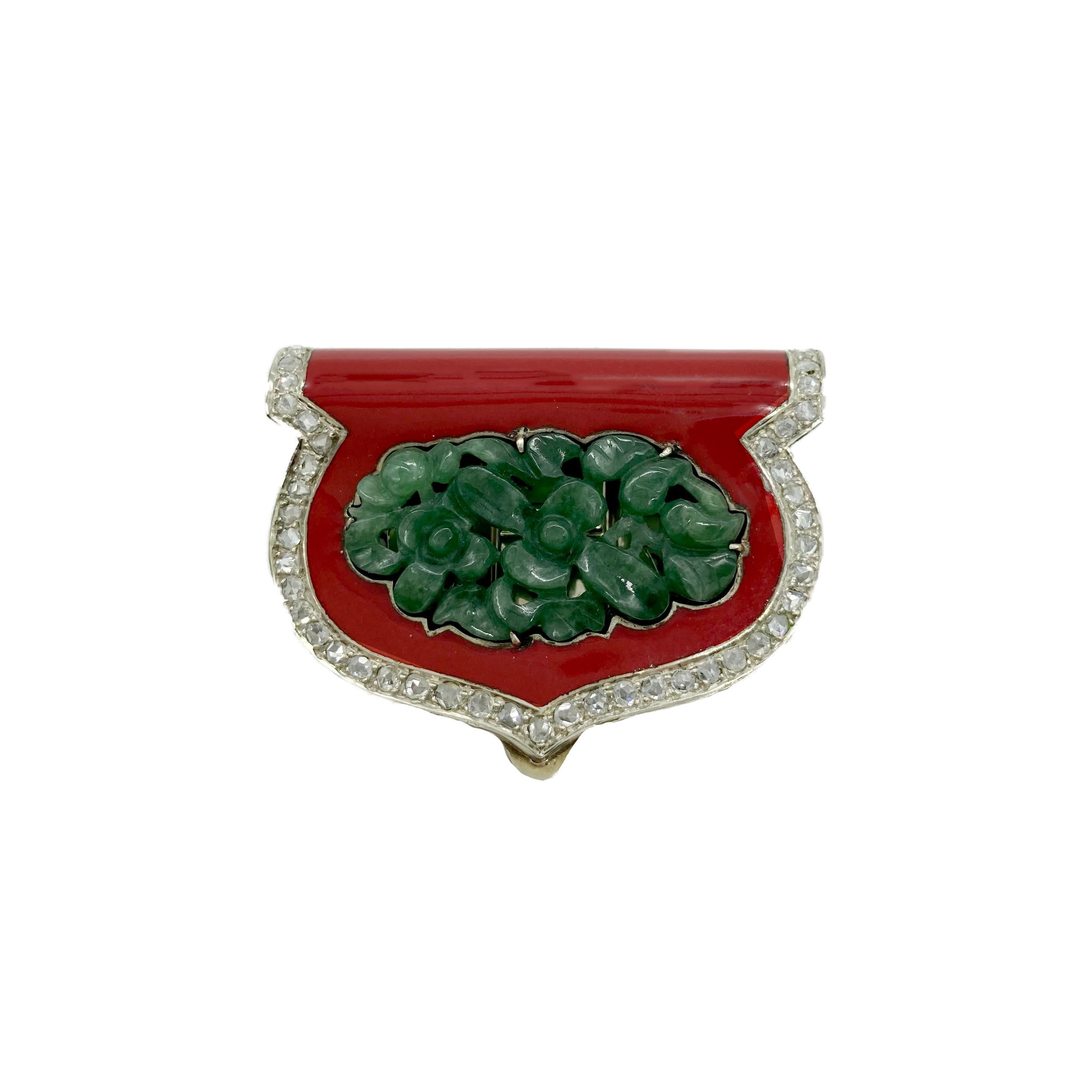 A beautiful Art Deco clip-brooch featuring carved jade, coral, and diamonds. Austria, circa 1920s.