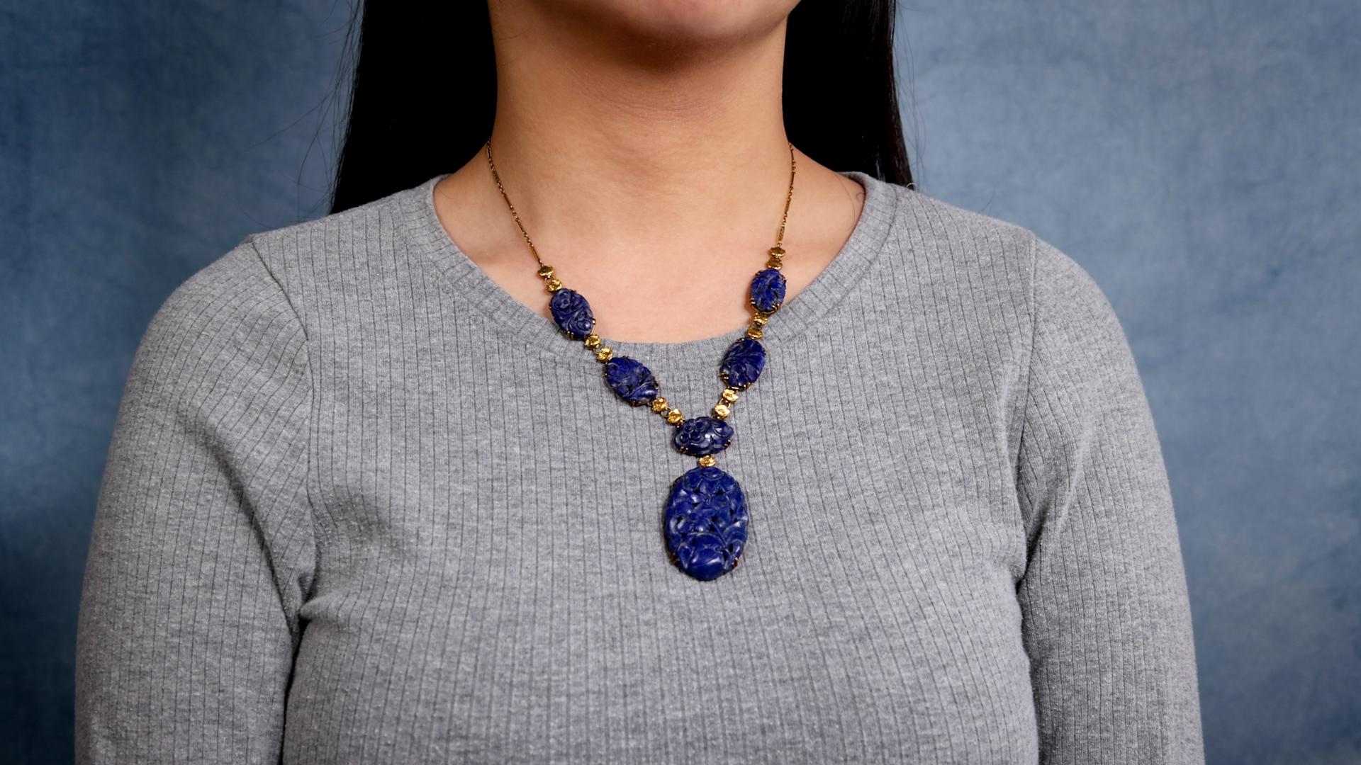 One Art Deco Carved Lapis Lazuli 14k Yellow Gold Necklace. Featuring six carved pieces of pyrite-speckled lapis lazuli. Crafted in 14 karat yellow gold with purity marks. Circa 1930. The necklace is 17 ½ inches in length.

About this Item: This Art