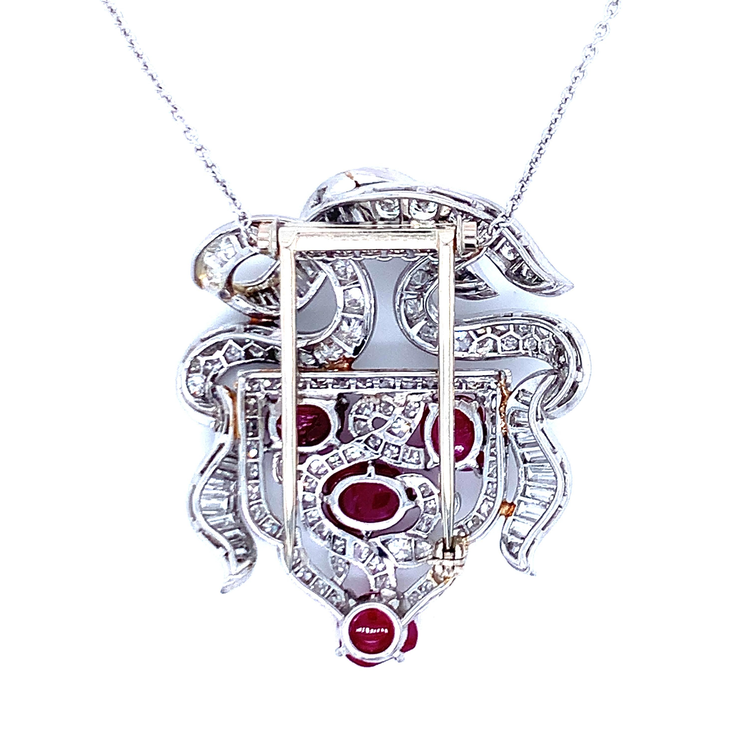 One Art Deco carved ruby and diamond platinum pendant featuring 4 carved, leaf motif cabochon rubies weighing a total of 4 ct. with GIA certificate confirming Burmese origin with no heat indications. The pendant is enhanced by 160 round brilliant