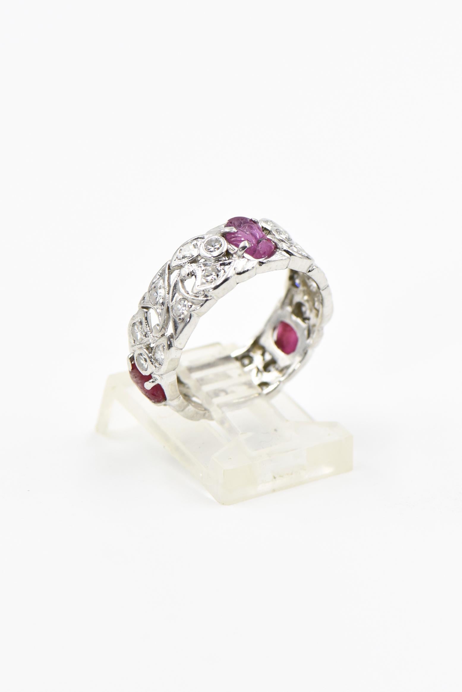 This stunning Art Deco platinum ring features 3 rubies with leaf carvings prong set between diamond vines.  The ring has approximately 1 carat of diamonds.  

US size 7.