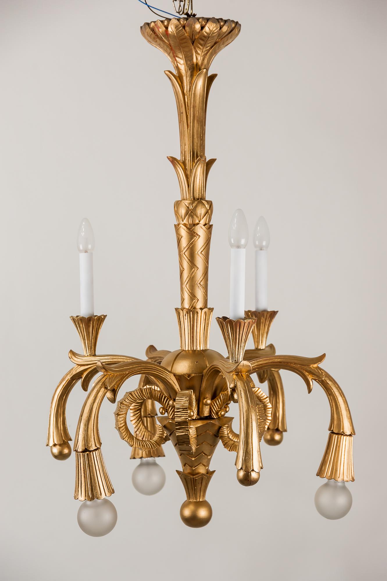 Art Deco carved wood chandelier, 1930s
Painted gold color
6 bulbs
Original condition.
 