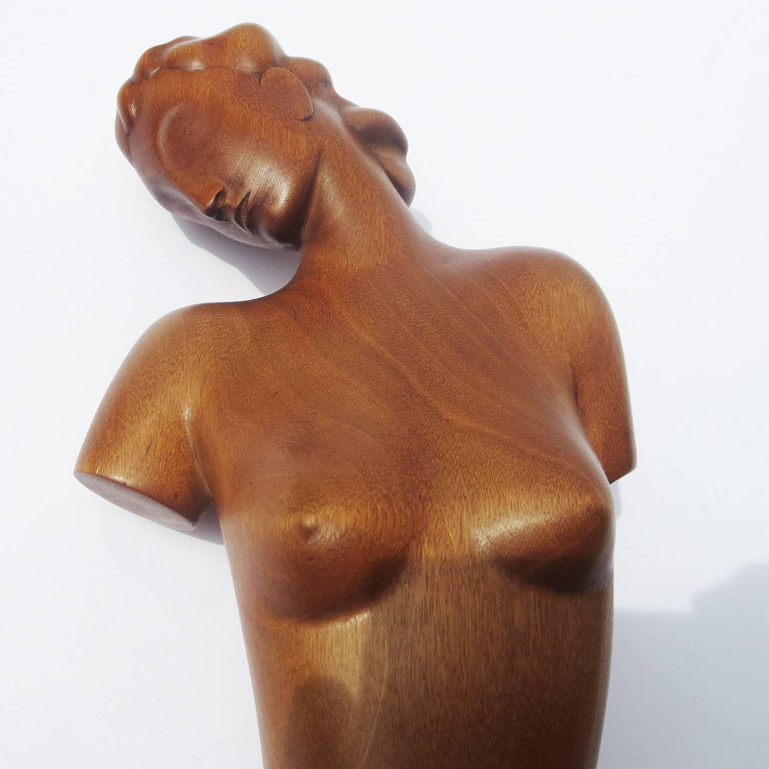 This lovely sculpture displays all the Classic elements of the streamlined style of Hagenauer, from the vague facial features to the sweeping form. The figure is hand-carved polished mahogany, mounted onto a flat brass base. The underside is stamped