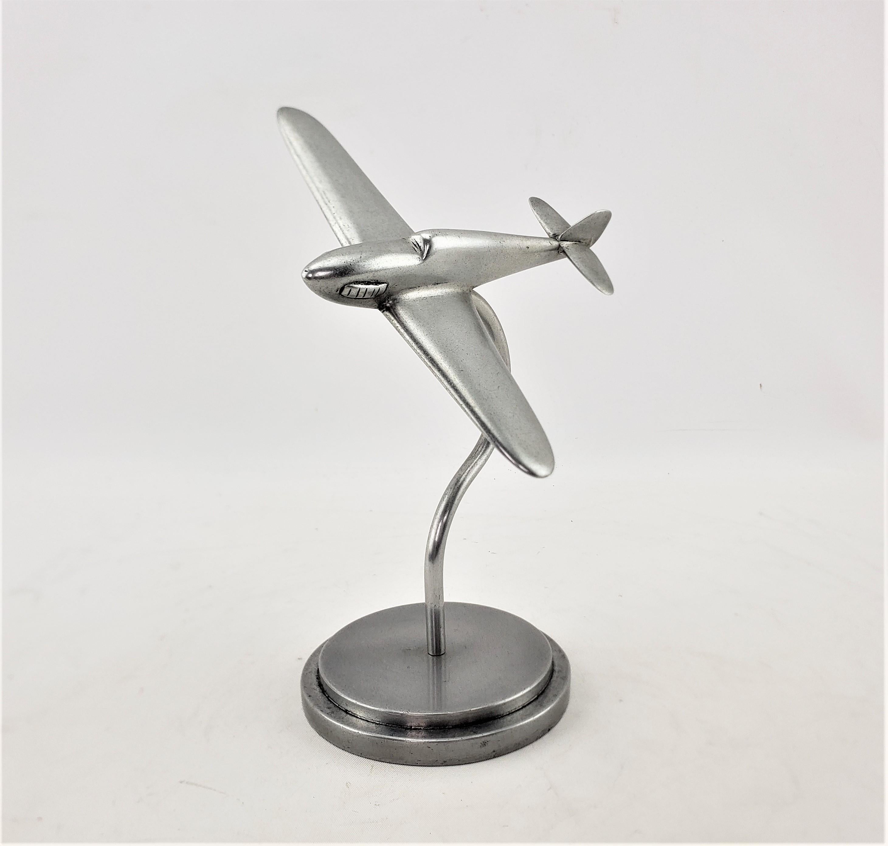 This airplane model or sculpture is unsigned, but presumed to have originated from the United States and dating to approximately 1920 and done in the period streamlined Art Deco style. The plane is composed of cast and brushed aluminum and is some