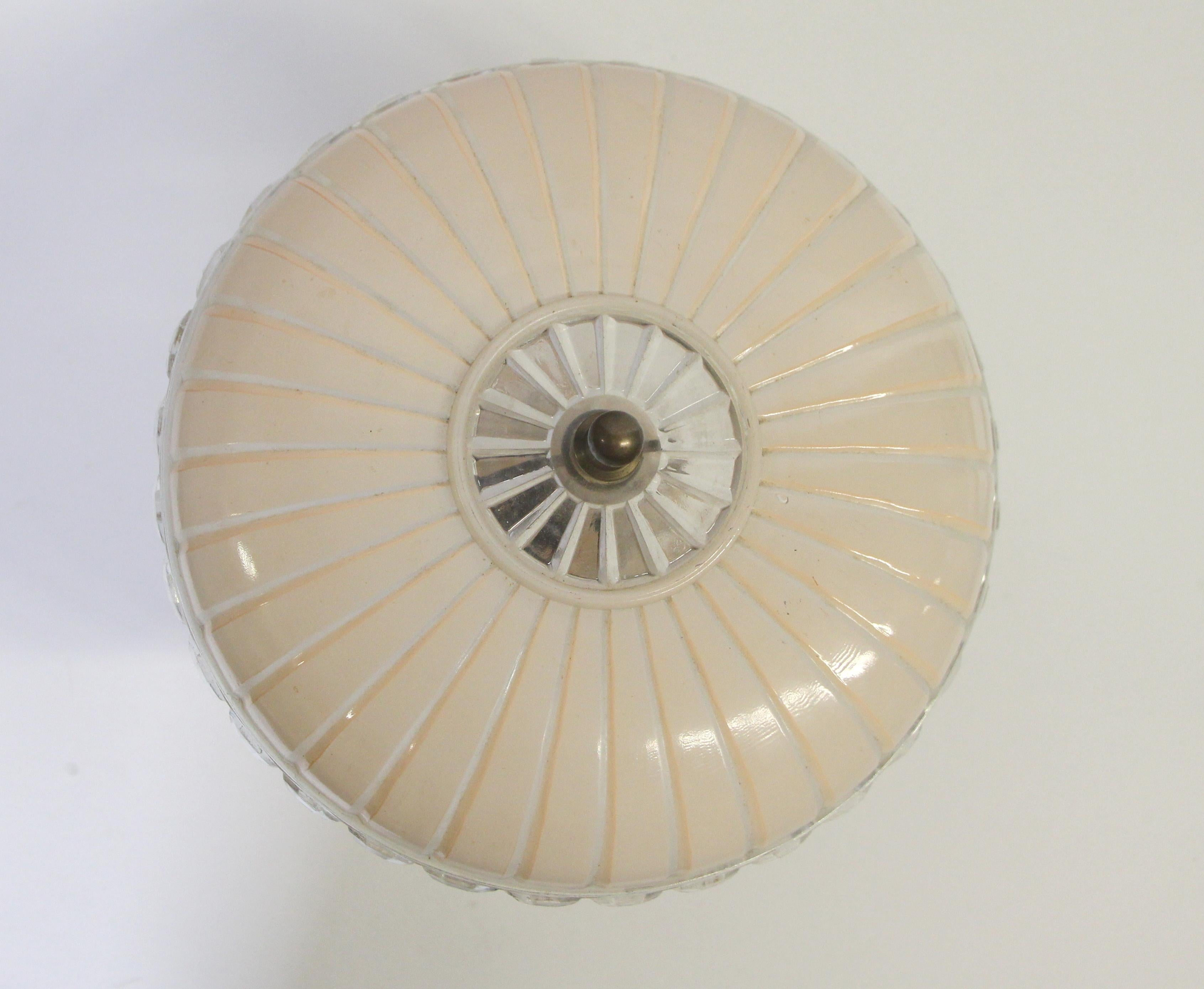 This light fixture originally from the 1940's has an Art Deco style and has light pink and clear glass. It hangs semi flush with one downward light. Price includes restoration. This can be seen at our 400 Gilligan St location in Scranton, PA.

