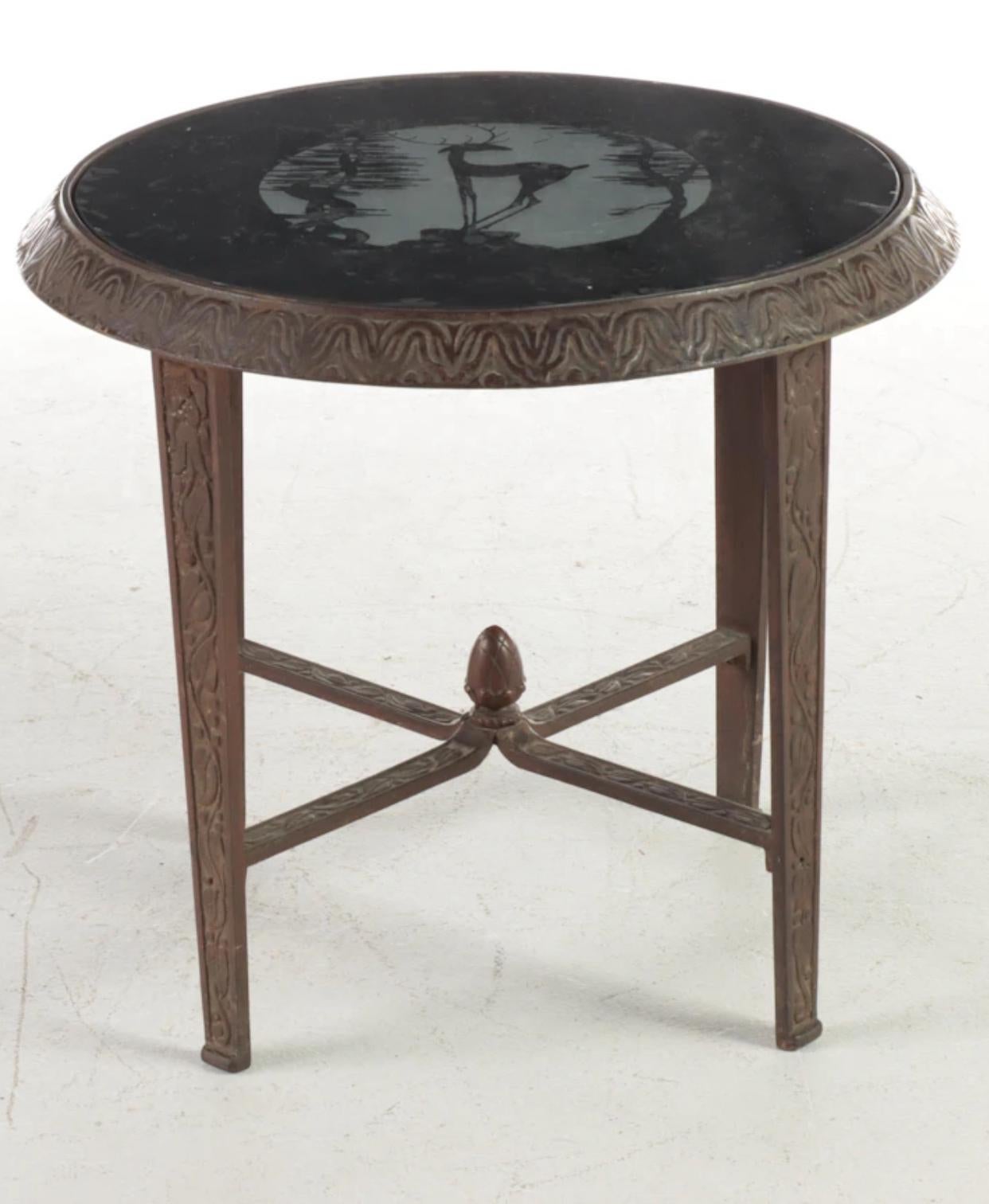 Art Deco cast iron side table with a beautiful black, cut to frosted vitrolite top. Crisp cast iron that has been stripped of any lacquer or enamel. A few areas of oxidation that can be polished out if desired. 