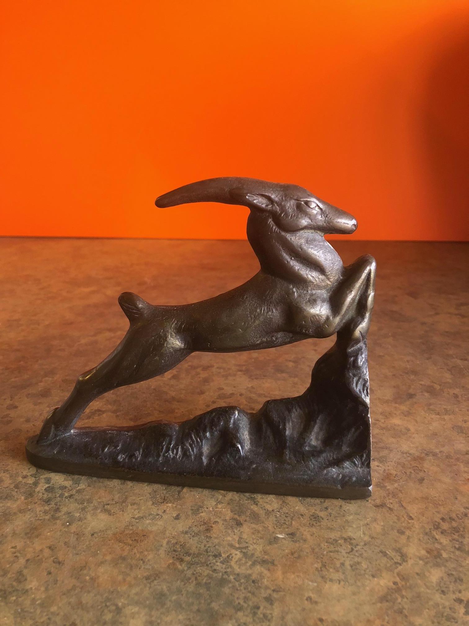 A very nice vintage Art Deco style Gazelle cast iron door stop or book end by Littlestown Hardware and Foundry of Pennsylvania, circa 1920s.

The piece is quite heavy and has a great patina and depicts a lithe, leaping gazelle with a tremendous