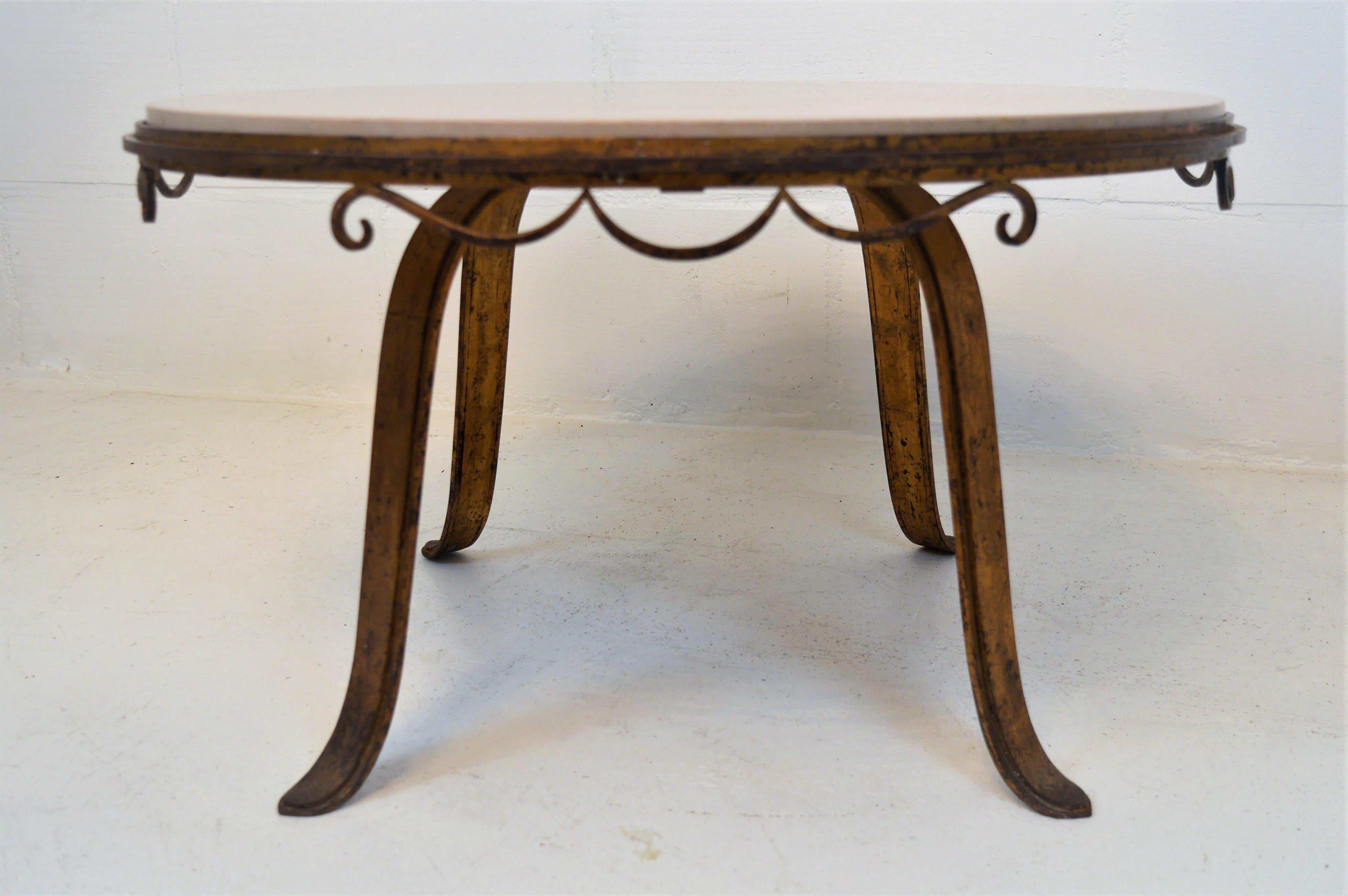 Distinguist cast-iron gilded coffee-table with marble top, probably designed by the French artist Raymond Subes.