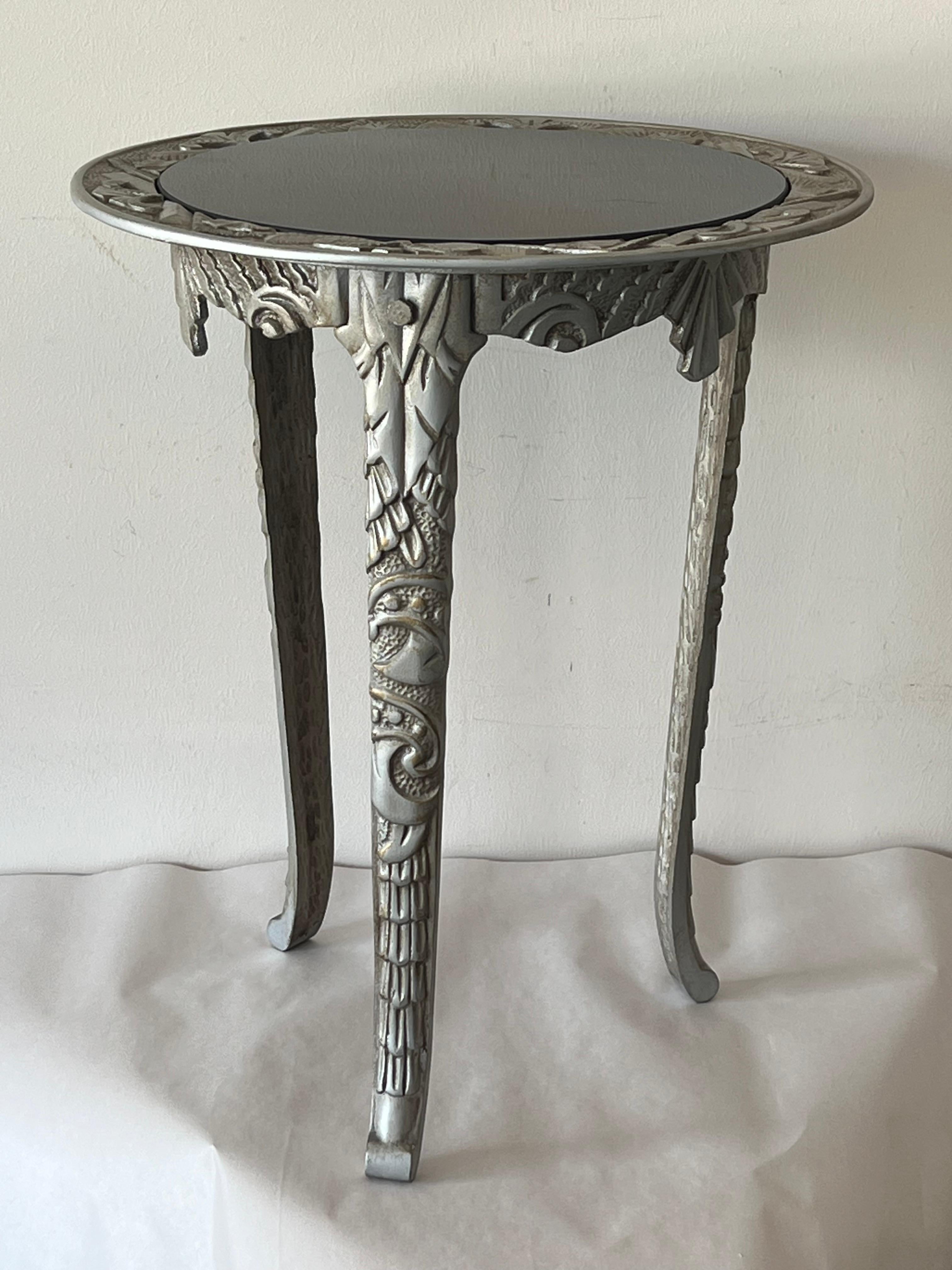 An elegant and heavy cast iron table ca' 1930's. Inset black glass top. Made in Geneval Ilinois, USA. 