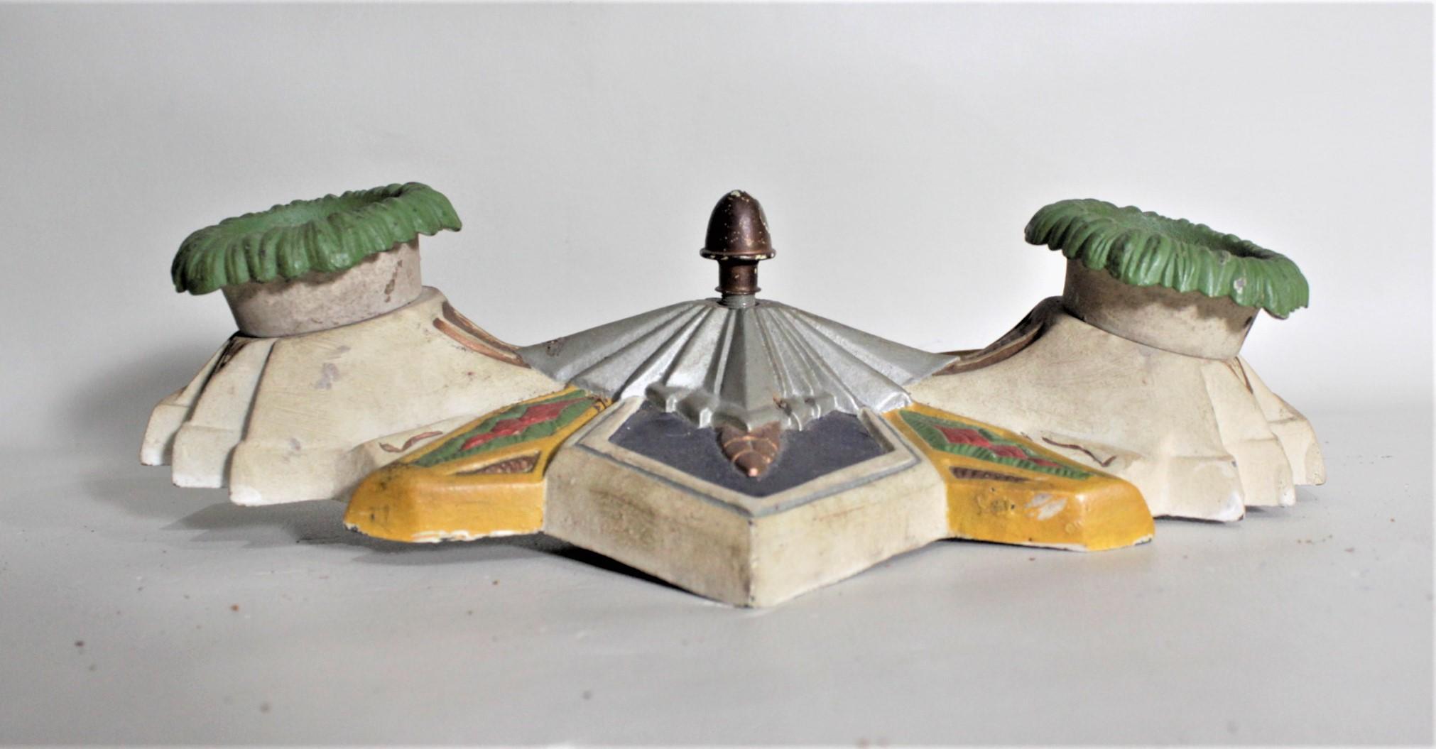 This cast metal flushmount ceiling light fixture is unsigned but presumed to have been made in the United States in circa 1935 in the period Art Deco style. The casting is quite detailed, showing several levels of the stepped Deco design with linear