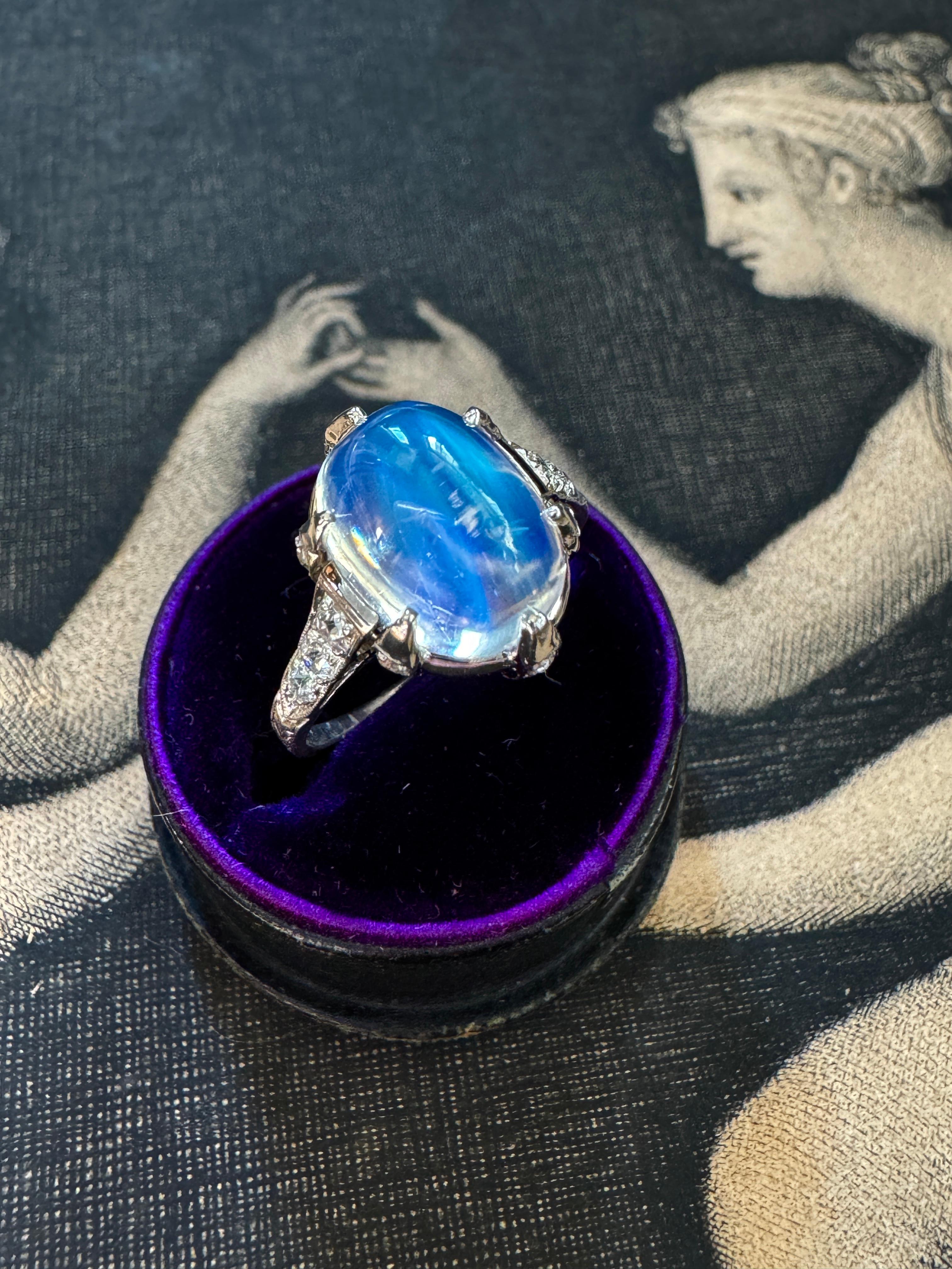 A luminous high domed (4.39 carat) cabochon moonstone glows from within six diamond-set platinum prongs, beautifully complimented by diamond lined shoulders with delicate hand engraving. Currently a ring size 7.25

 

Diamonds: approximately .52ctw,