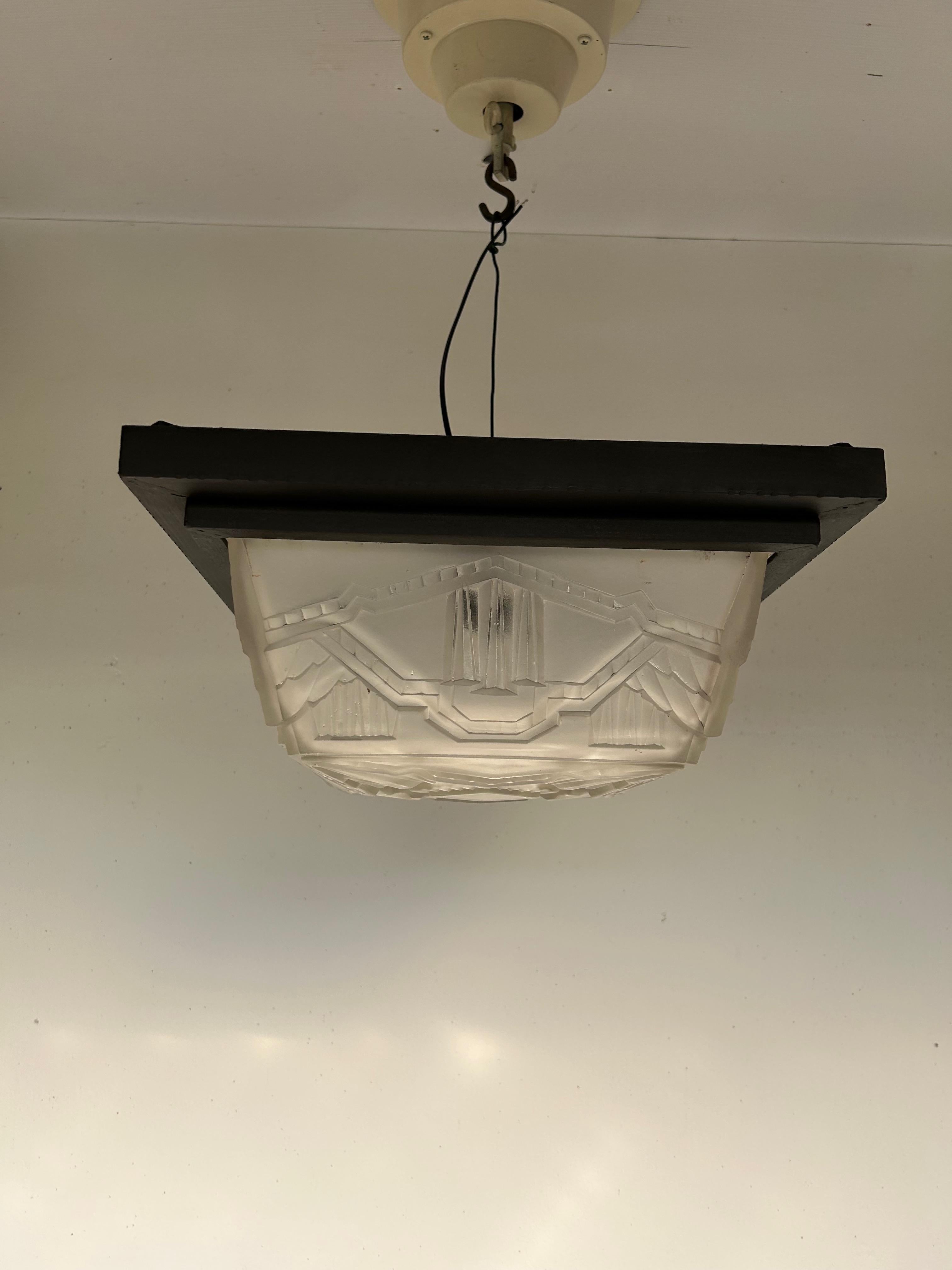 Art deco ceiling light circa 1930. wrought iron frame with black patina and molded glass with geometric decoration in the style of Hettier and Vincent, superb quality of molded glass, in perfect condition, electrified, B 22 socket, 100W LED screw