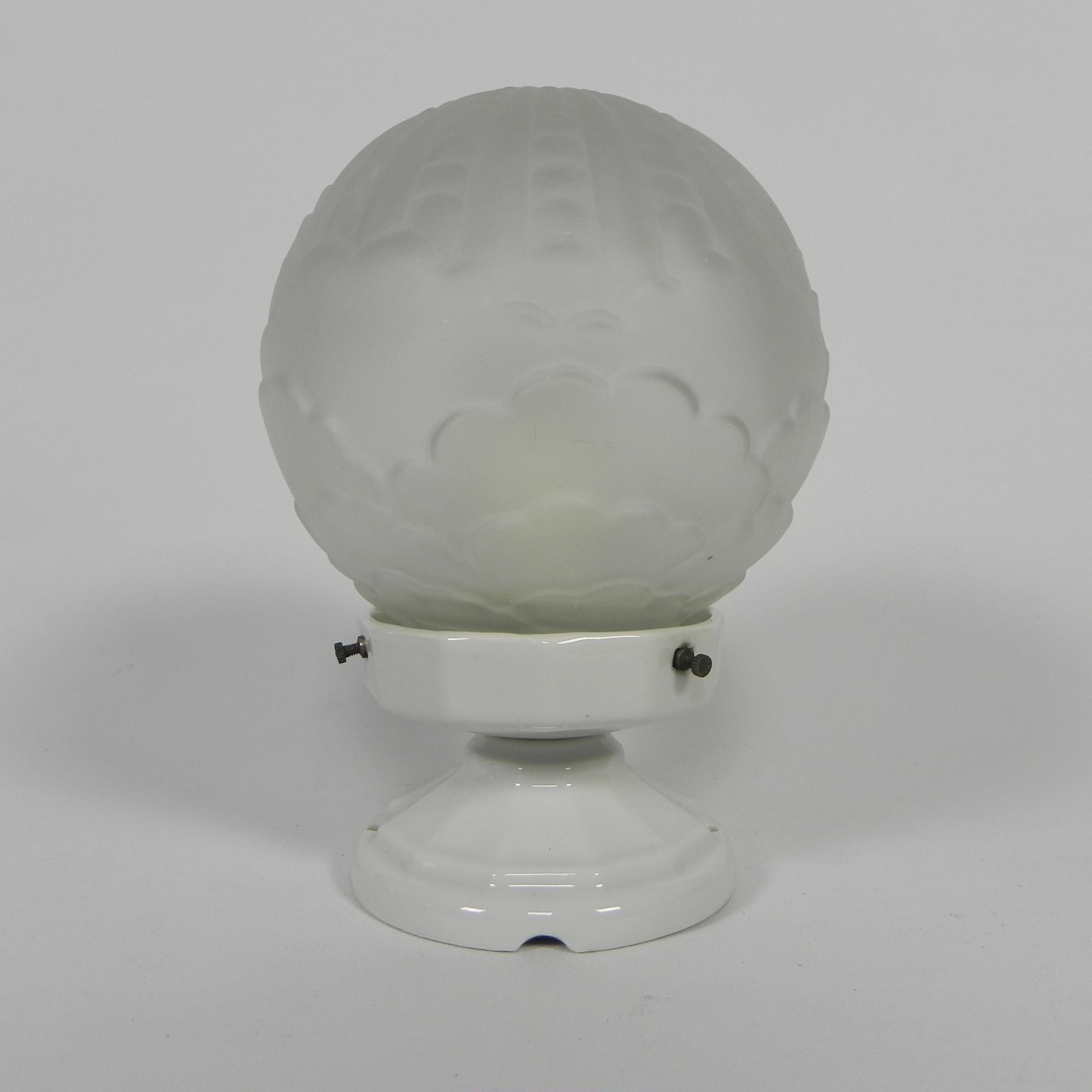 This ceiling lamp has a special porcelain holder
that can be attached to the ceiling with 2 screws

Total height: 20 cm.
Ø glass shade: 14 cm.
The lamp has a large fbulb holder (E27).
Origin: France, 1930s.
Material: porcelain / glass.