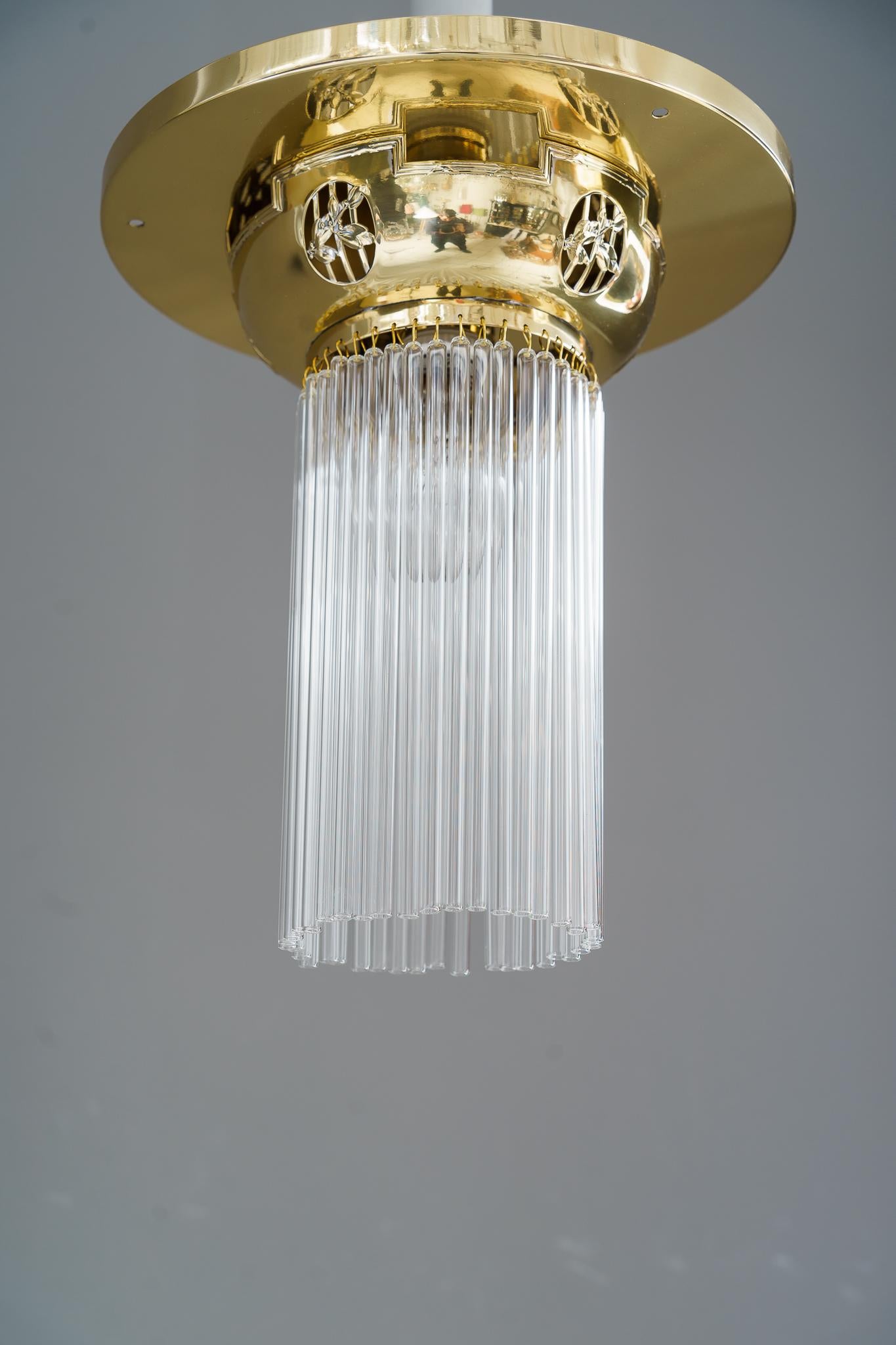 Art Deco ceiling lamp with glass sticks vienna around 1920s 
Brass polished and stove enameled
Glass sticks are replaced ( new ).