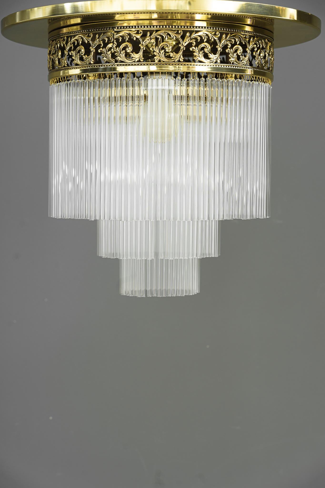 Art Deco ceiling lamp with glass sticks, Vienna, around 1920s.
The glass sticks are replaced.
Polished and stove enameled.