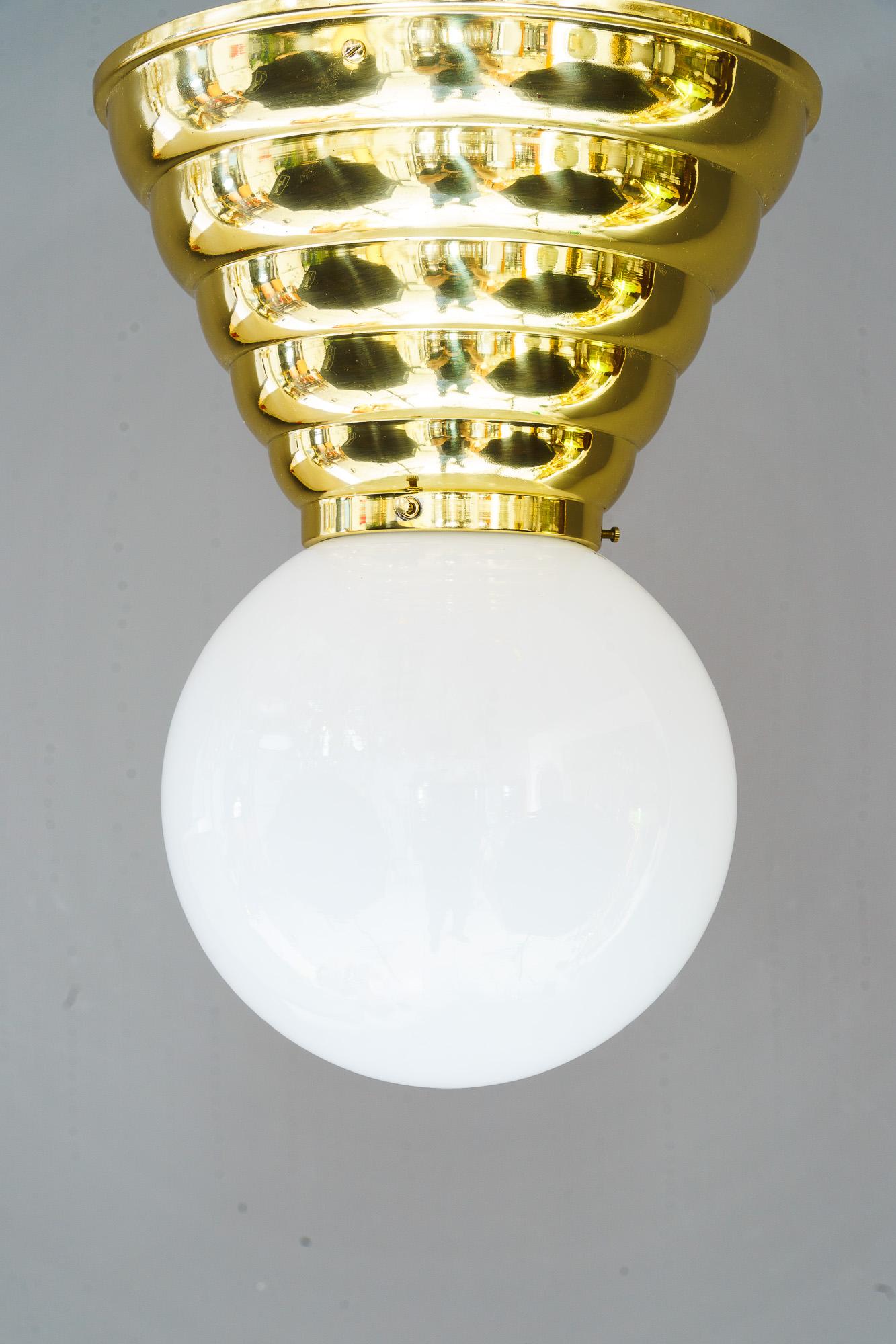 Art Deco ceiling lamp with opal glass shade vienna around 1920s
Brass polished and stove enameled
Original antique opal glass shade
